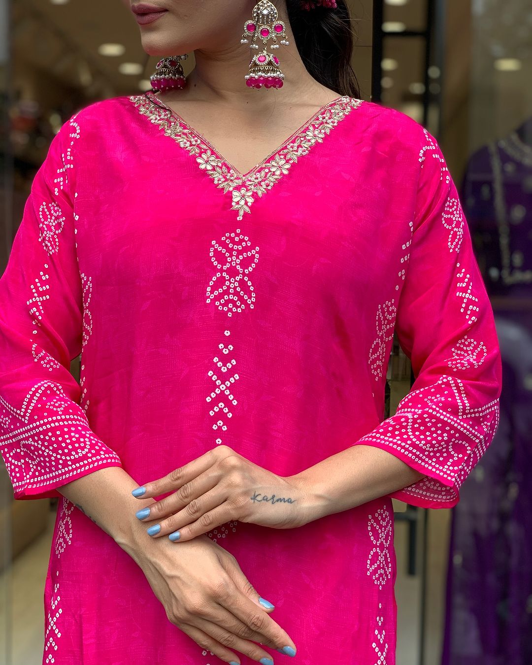 Detailed shot of V-neckline with golden embroidery and traditional print on TRENDBUY Rani Pink kurti