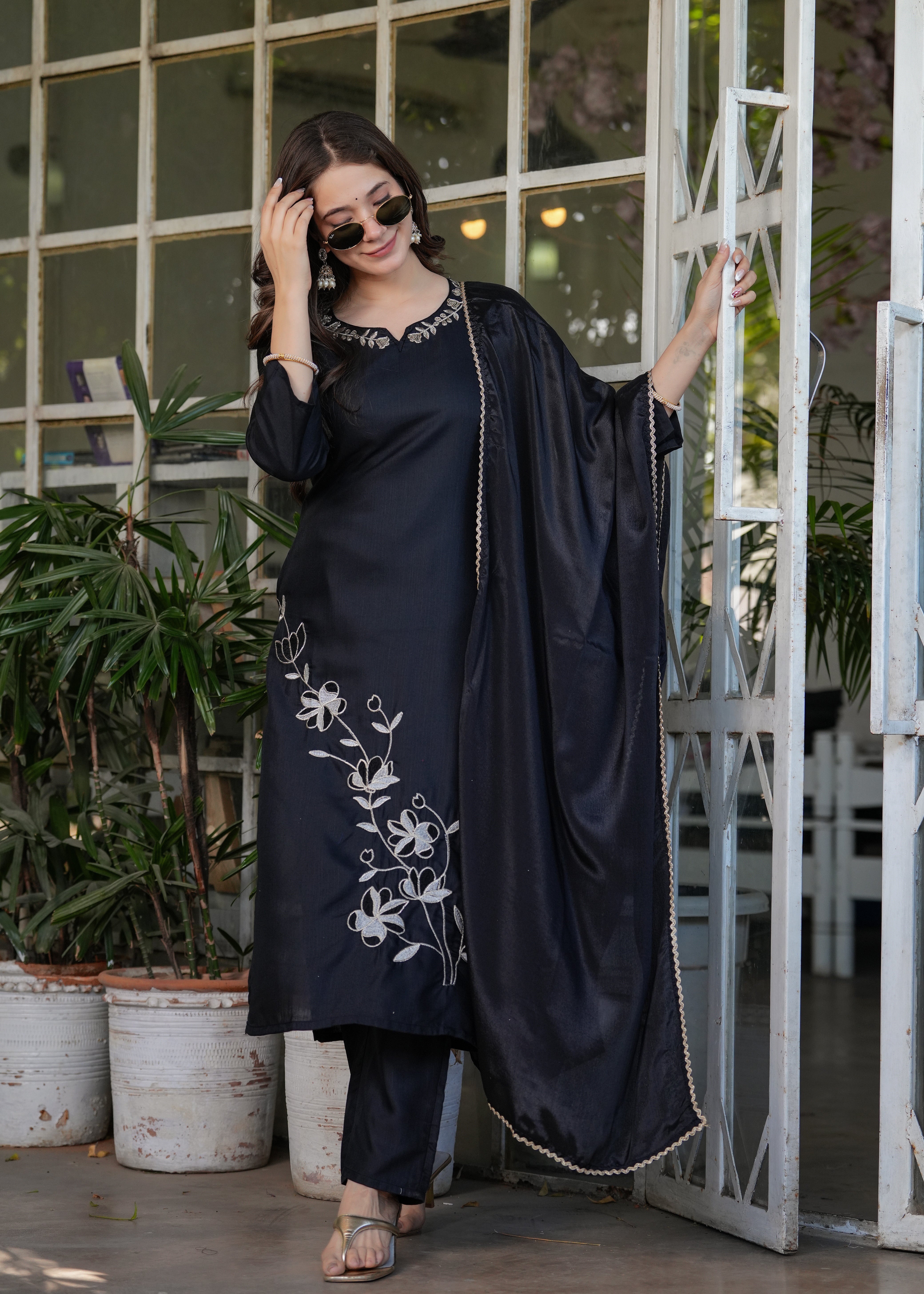 Model in elegant black embroidered kurta and pant set with flowy black dupatta, showcasing the outfit's drape.