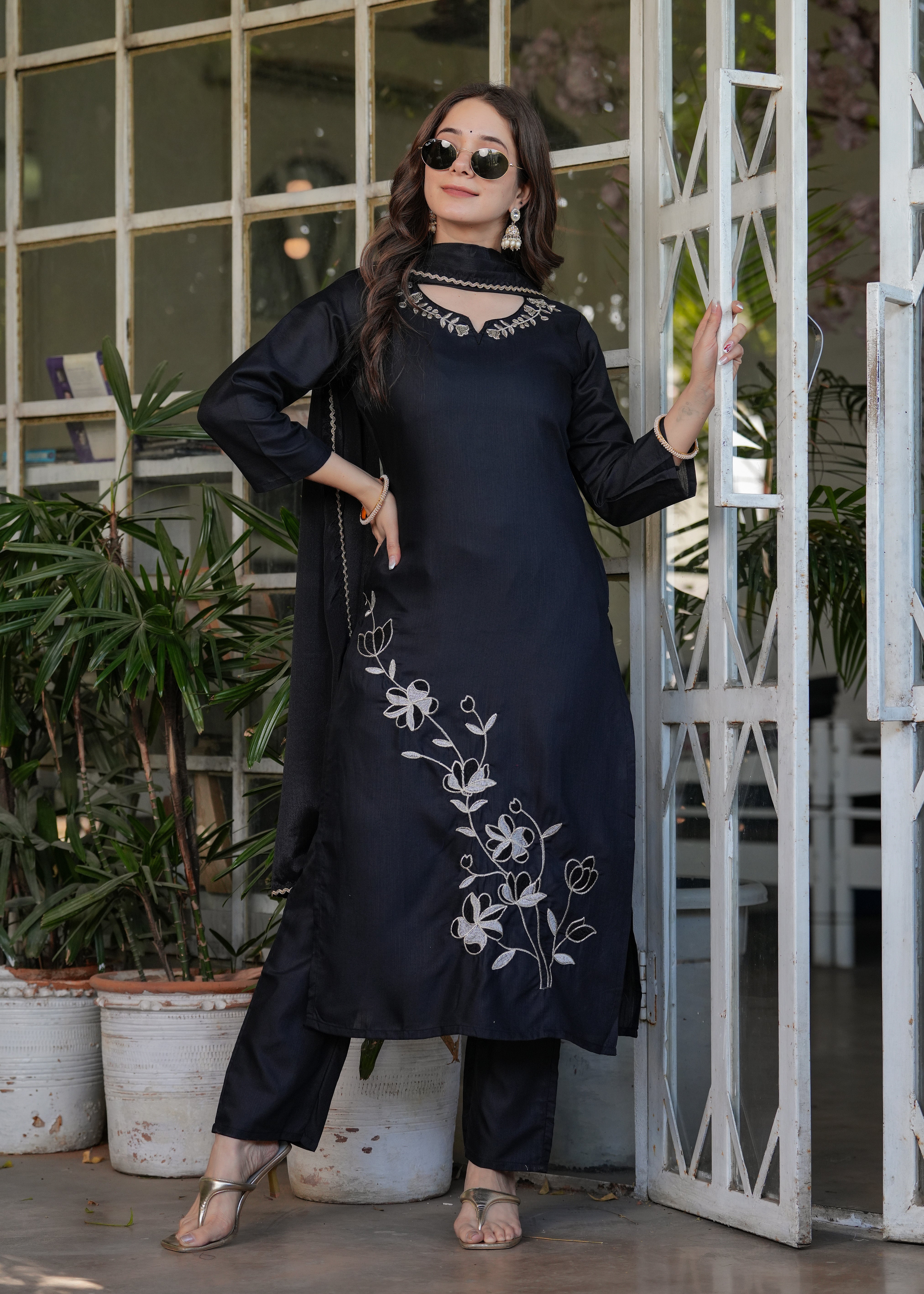 Full shot of woman showcasing black embroidered kurta with subtle neckline work and matching dupatta draped casually, perfect for TRENDBUY customers.