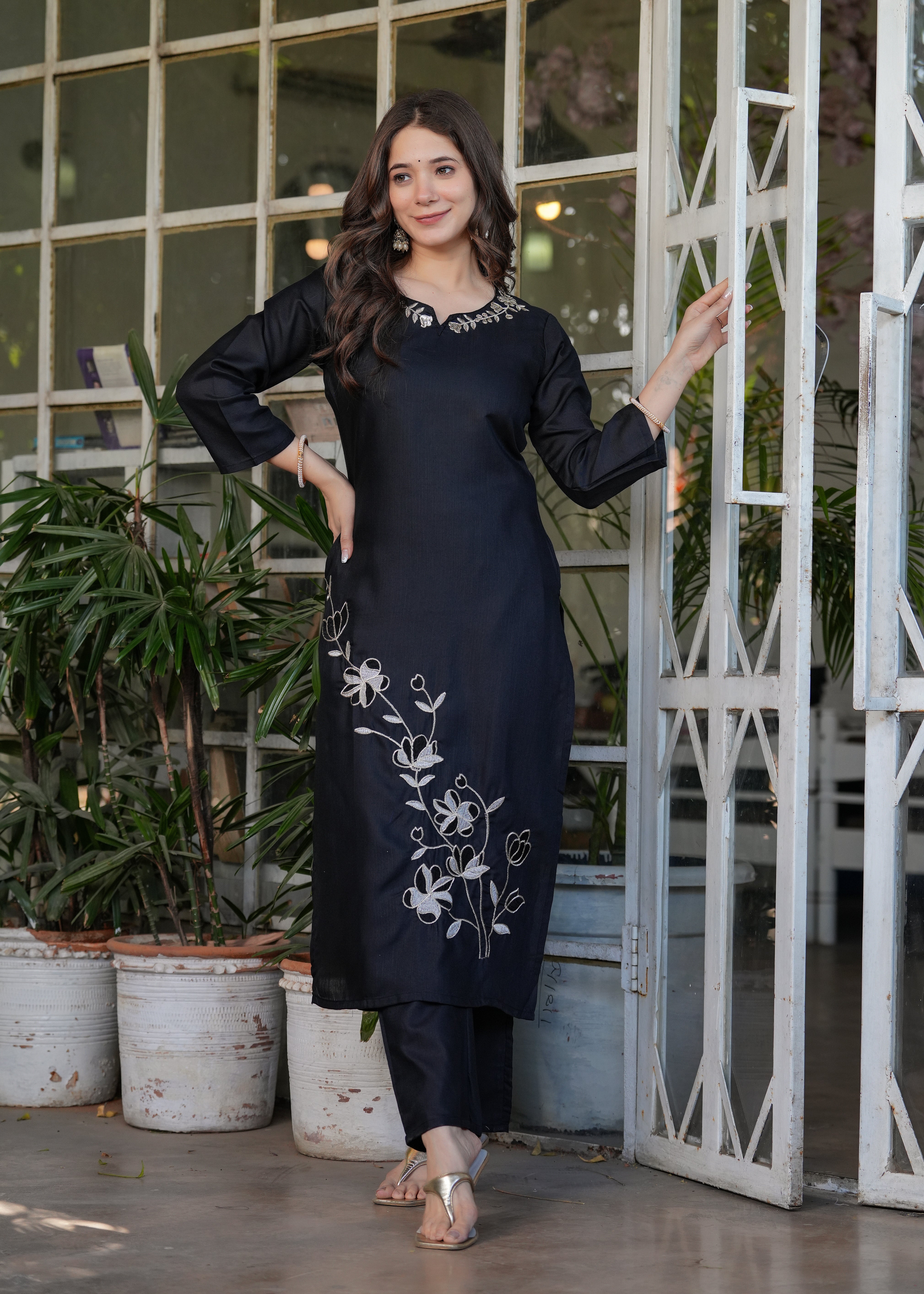 Woman smiling in a black viscose rayon kurta set, highlighting the delicate white floral embroidery on the kurta from TRENDBUY.