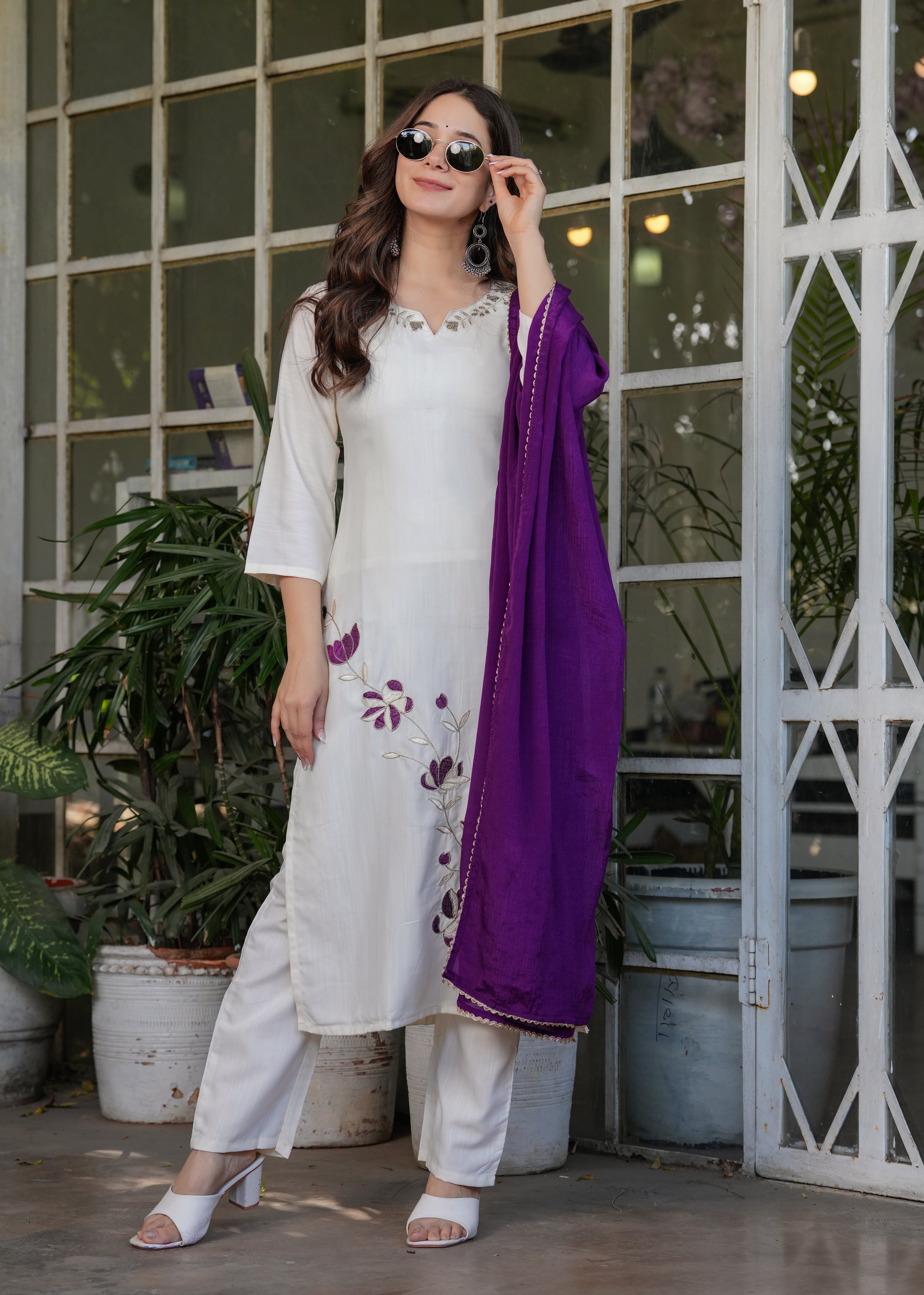 Woman showcasing the comfortable fit of the TRENDBUY off-white kurta and pant set, with a purple dupatta styled around her.