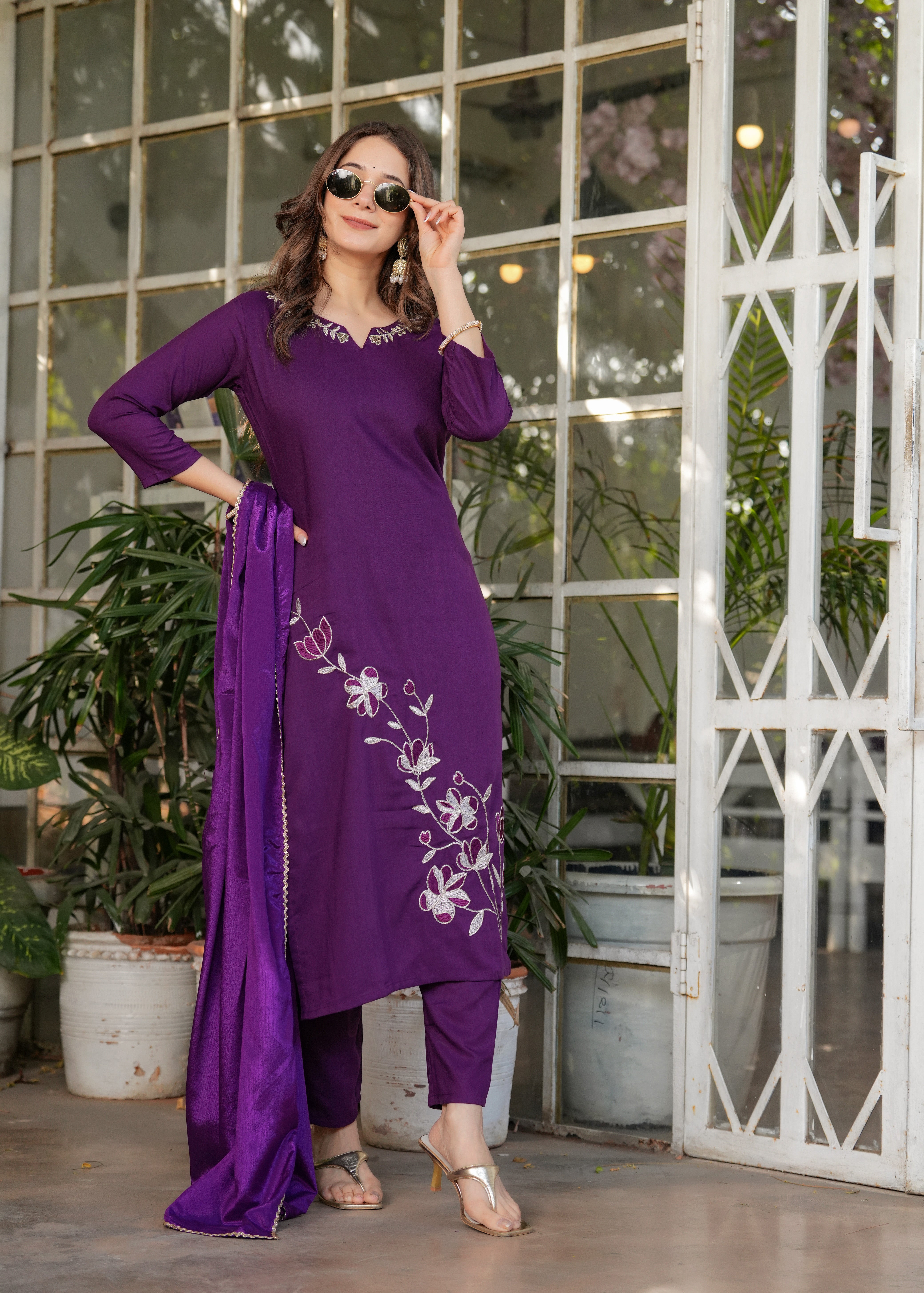 Model in stunning wine embroidered kurta and pant set, adjusting her sunglasses, showcasing TRENDBUY's fashion.