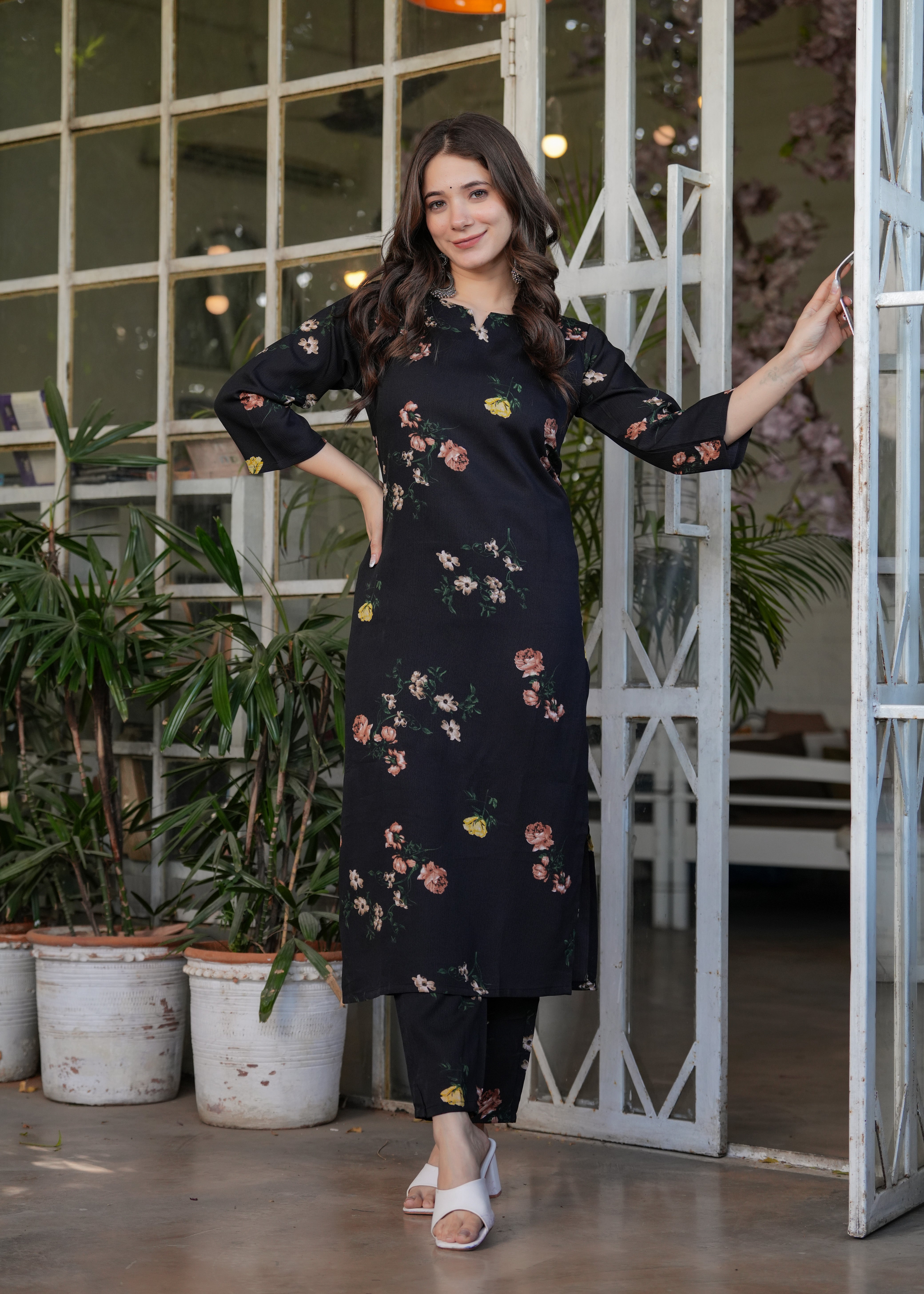 Woman smiling and posing naturally in the black silk blend printed straight kurti set, demonstrating its versatility and elegance.