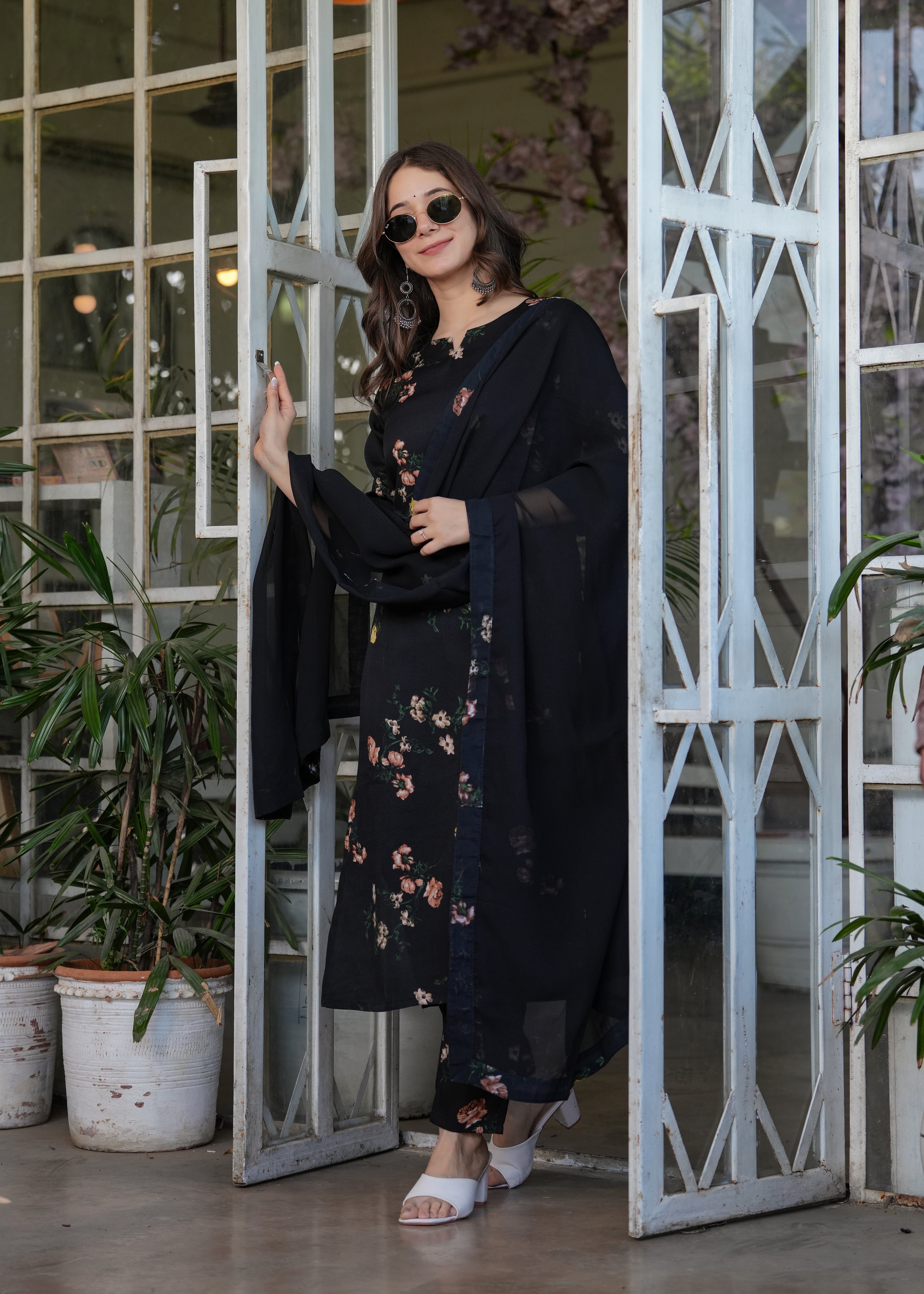 Full-length shot of a confident woman in the TRENDBUY black silk blend printed kurta set with dupatta, ready for a stylish outing.