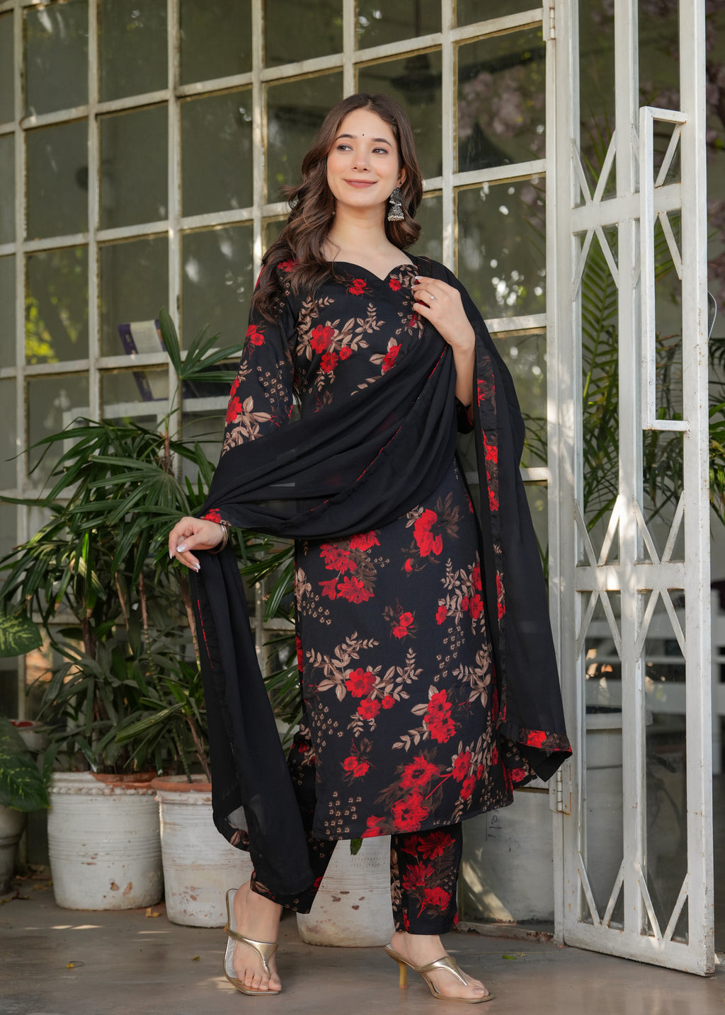 Full shot of woman in black silk blend printed kurta set with dupatta, elegant pose.