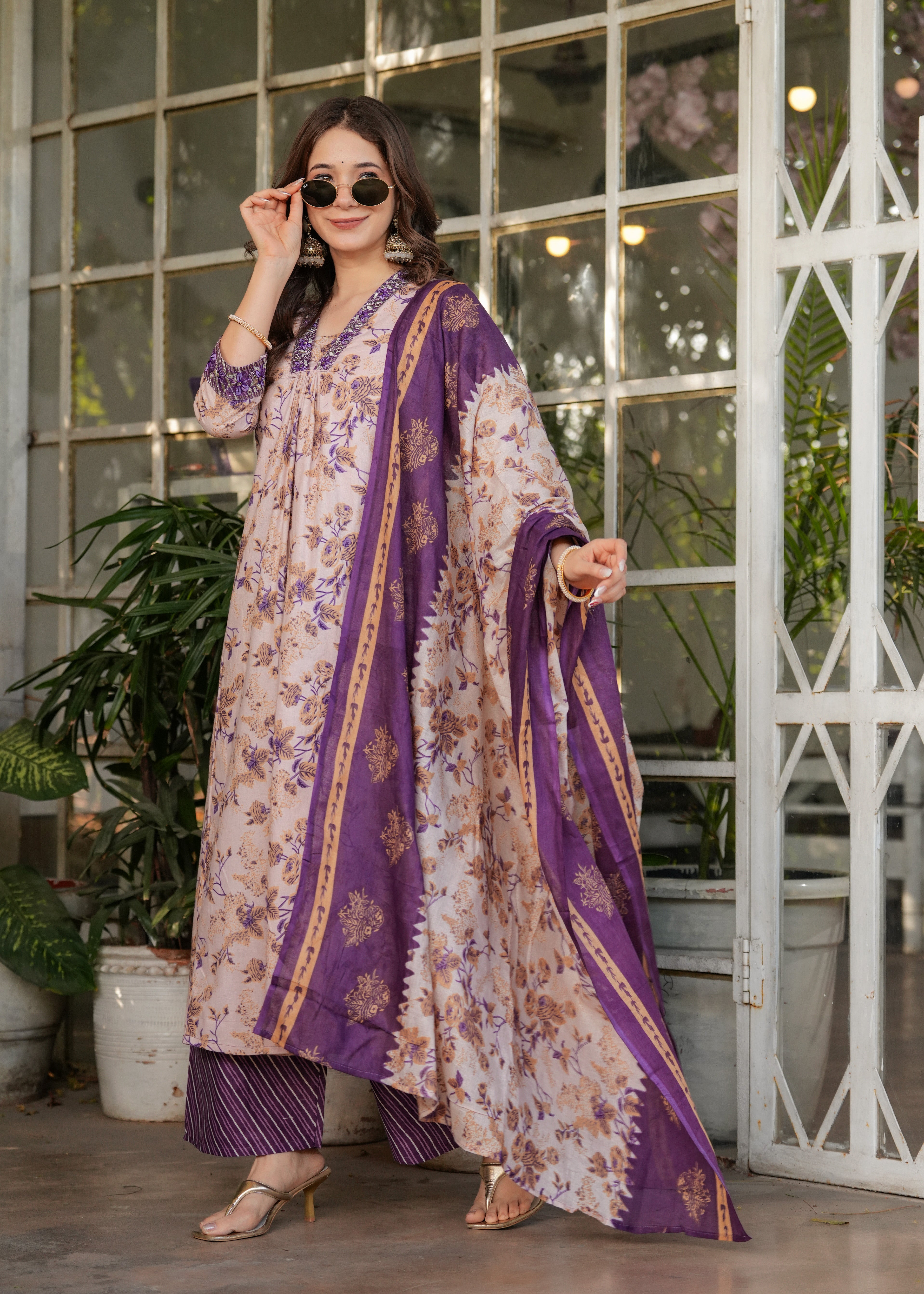 TRENDBUY model in cream and purple printed kurta set with sunglasses, looking stylish.