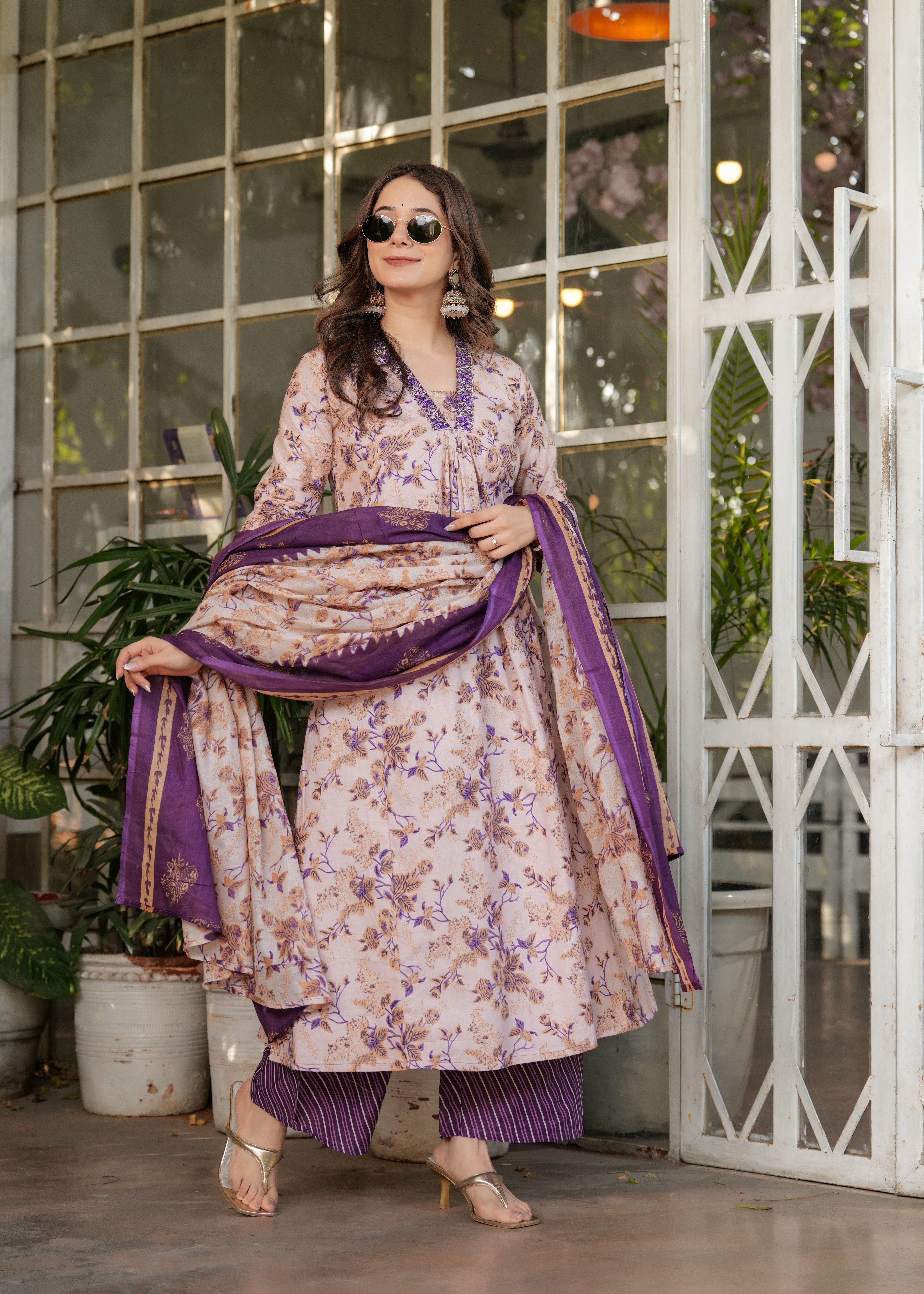 TRENDBUY ethnic wear model showcasing the beautiful floral print on the cream kurta and purple dupatta.