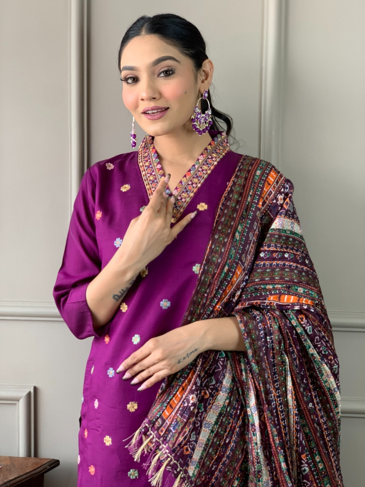 Woman posing with the vibrant, colorful printed Chinon dupatta elegantly draped over her purple embroidered kurta set from TRENDBUY.
