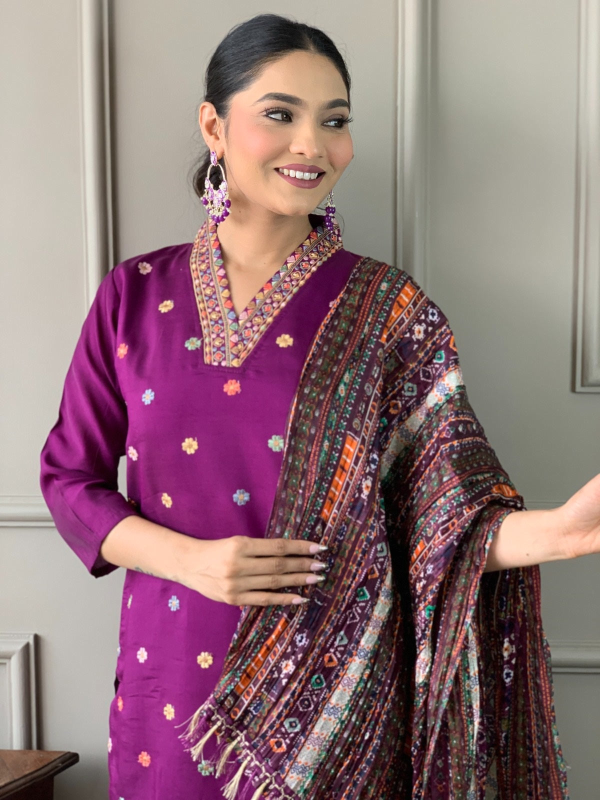 Side profile of woman in TRENDBUY purple kurta set, cheerfully displaying the ensemble's stylish design and comfort.