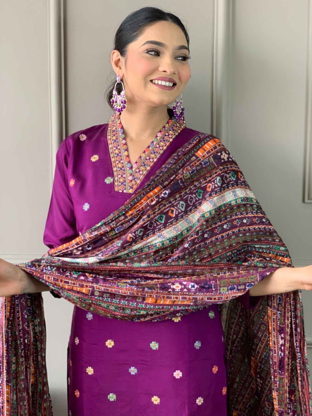 Woman presenting the full spread of the vibrant printed Chinon dupatta with tassels, part of the TRENDBUY kurta set.