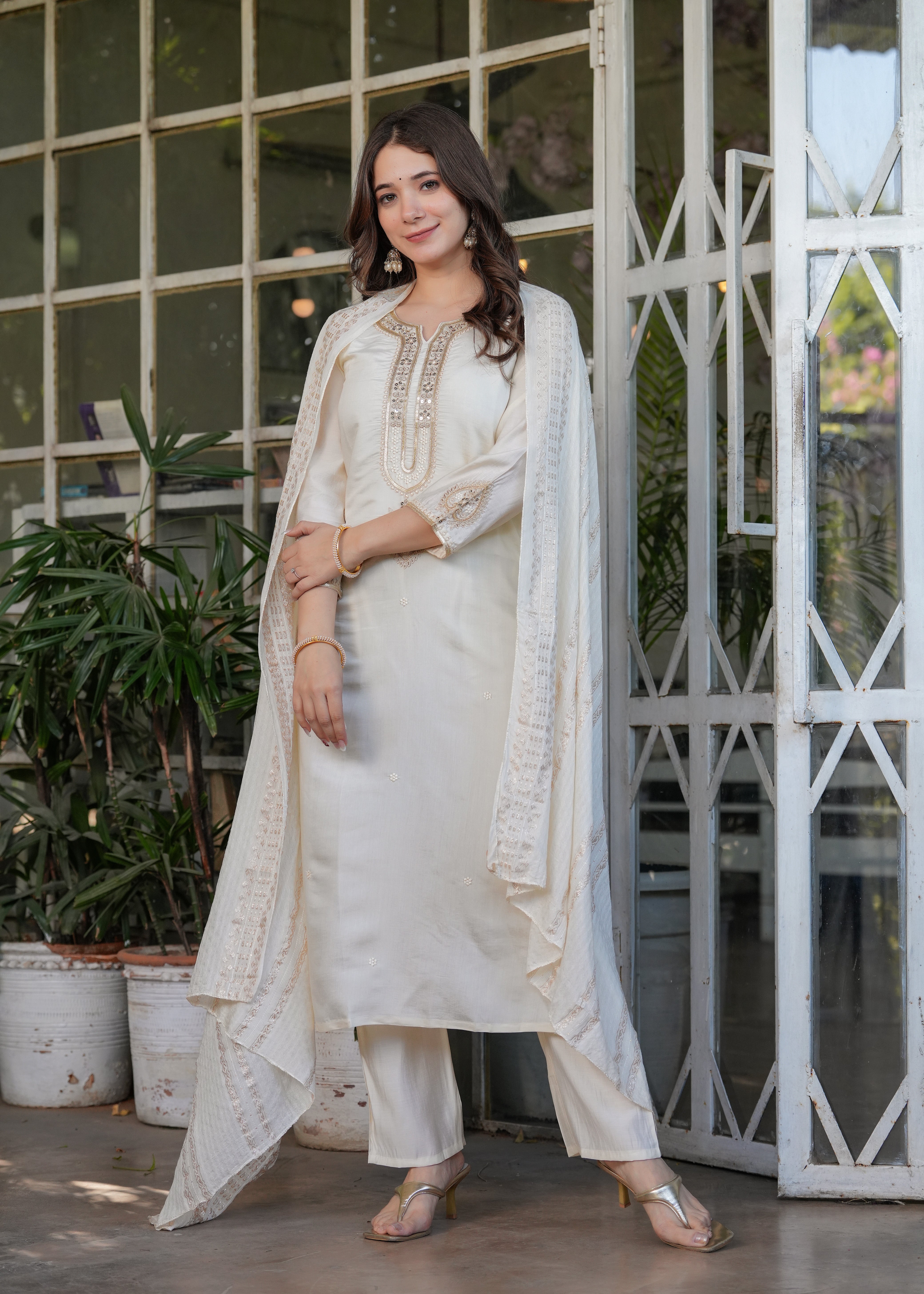 Graceful full length pose of TRENDBUY woman in off-white kurta set, dupatta flowing