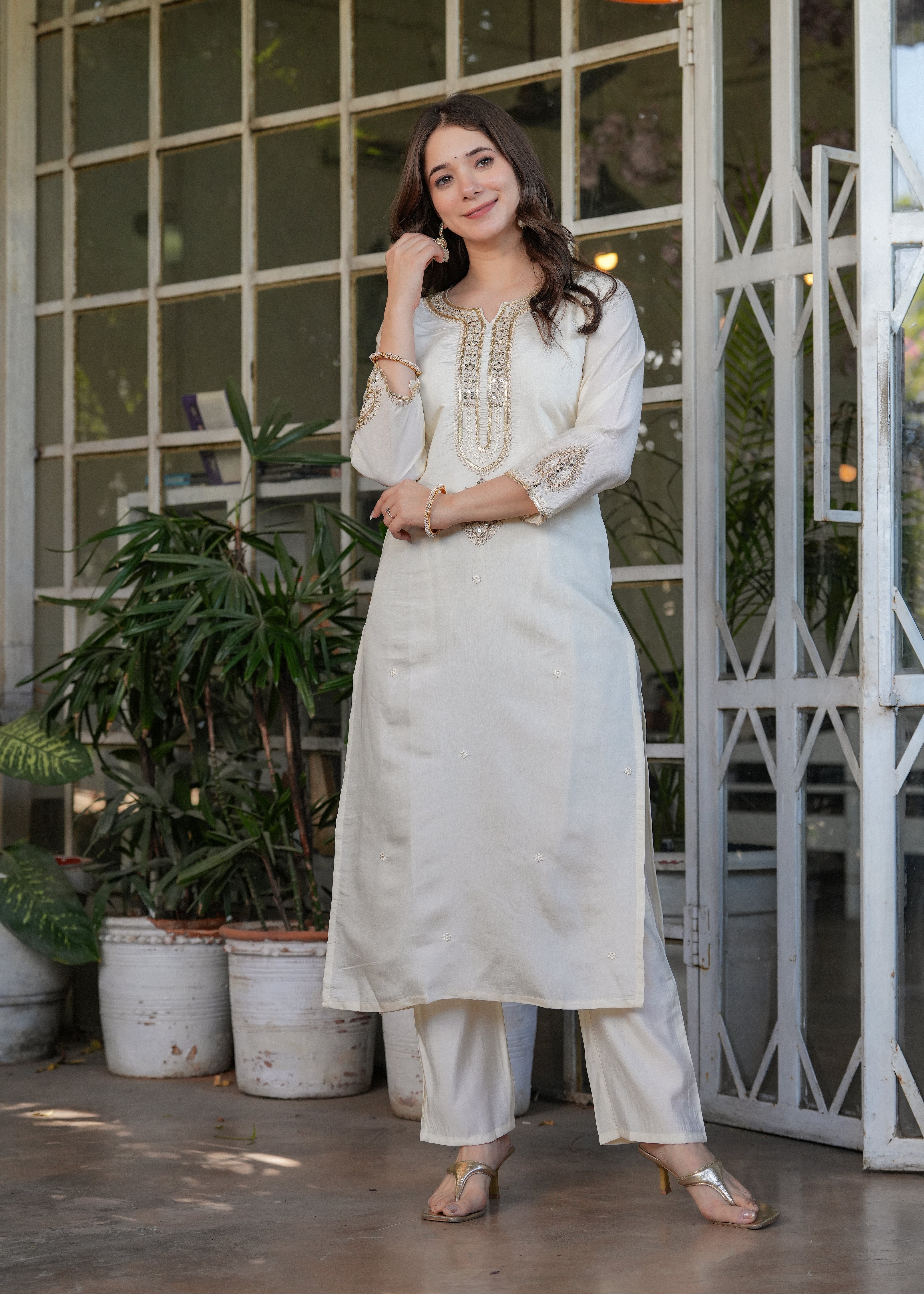 TRENDBUY woman posing gracefully in off-white embroidered kurta set, full length