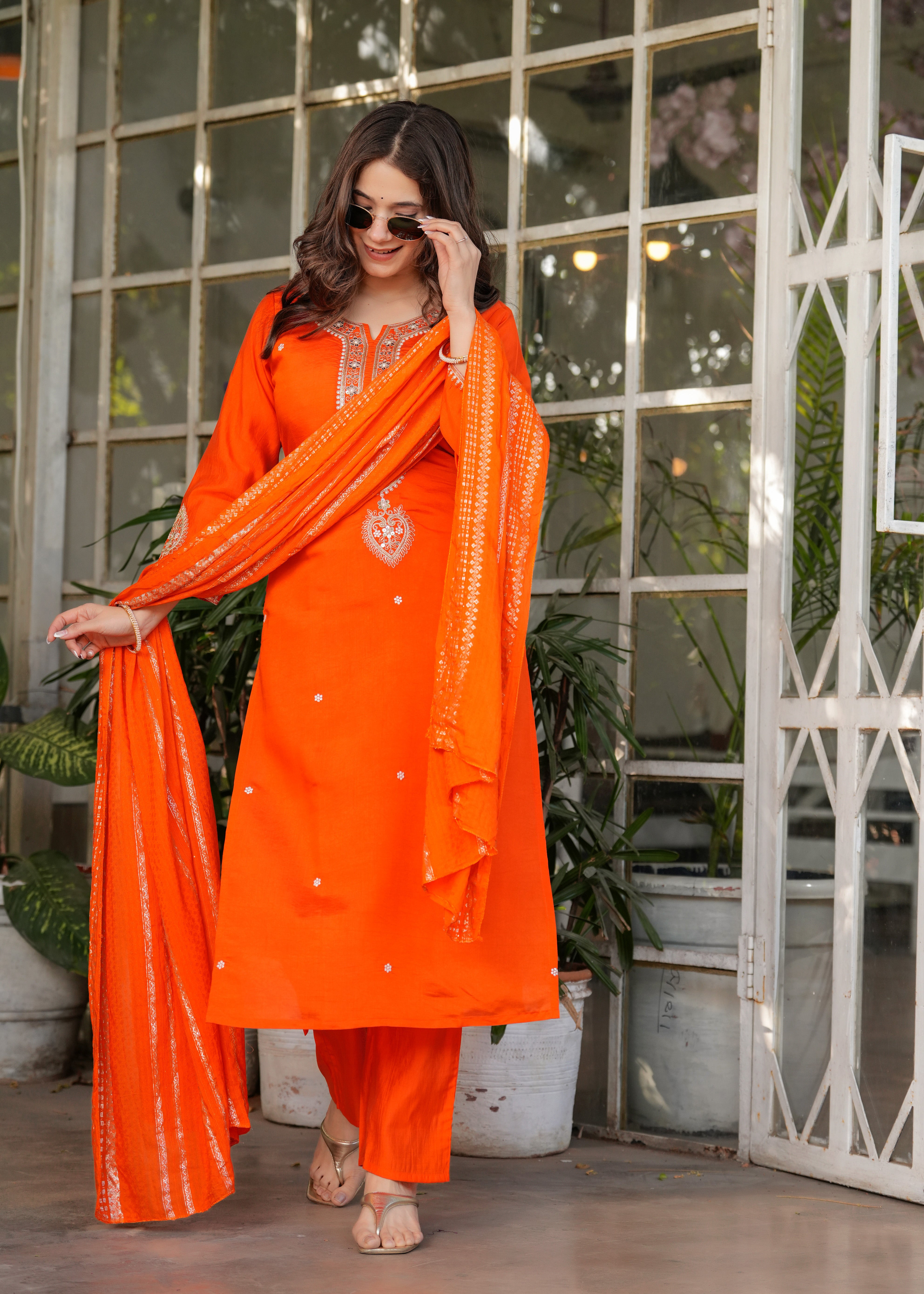 TRENDBUY woman in vibrant orange Viscose Chanderi embroidered kurta set with jacquard dupatta, full length, smiling