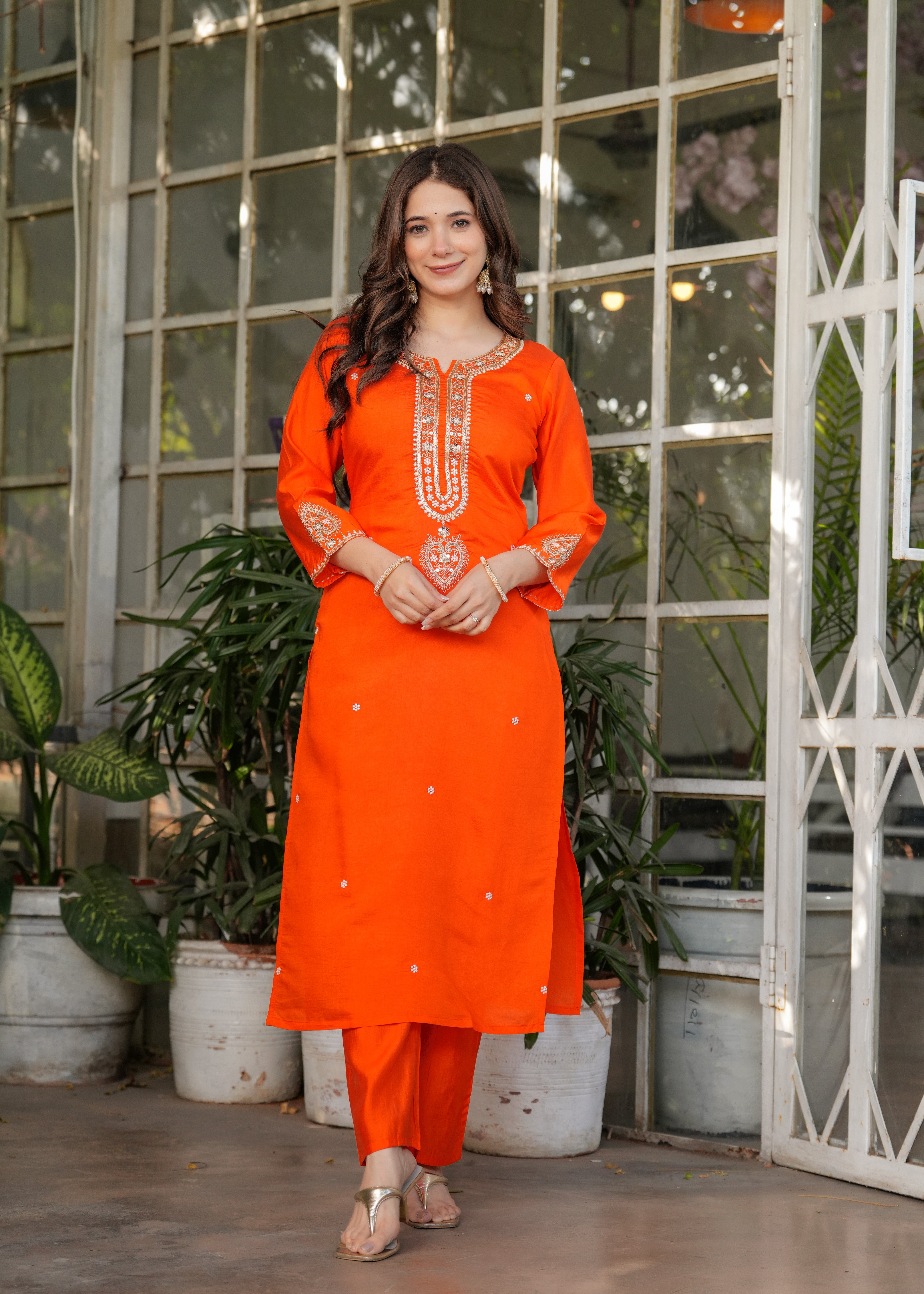 TRENDBUY woman posing with confidence in orange embroidered kurta set, front view