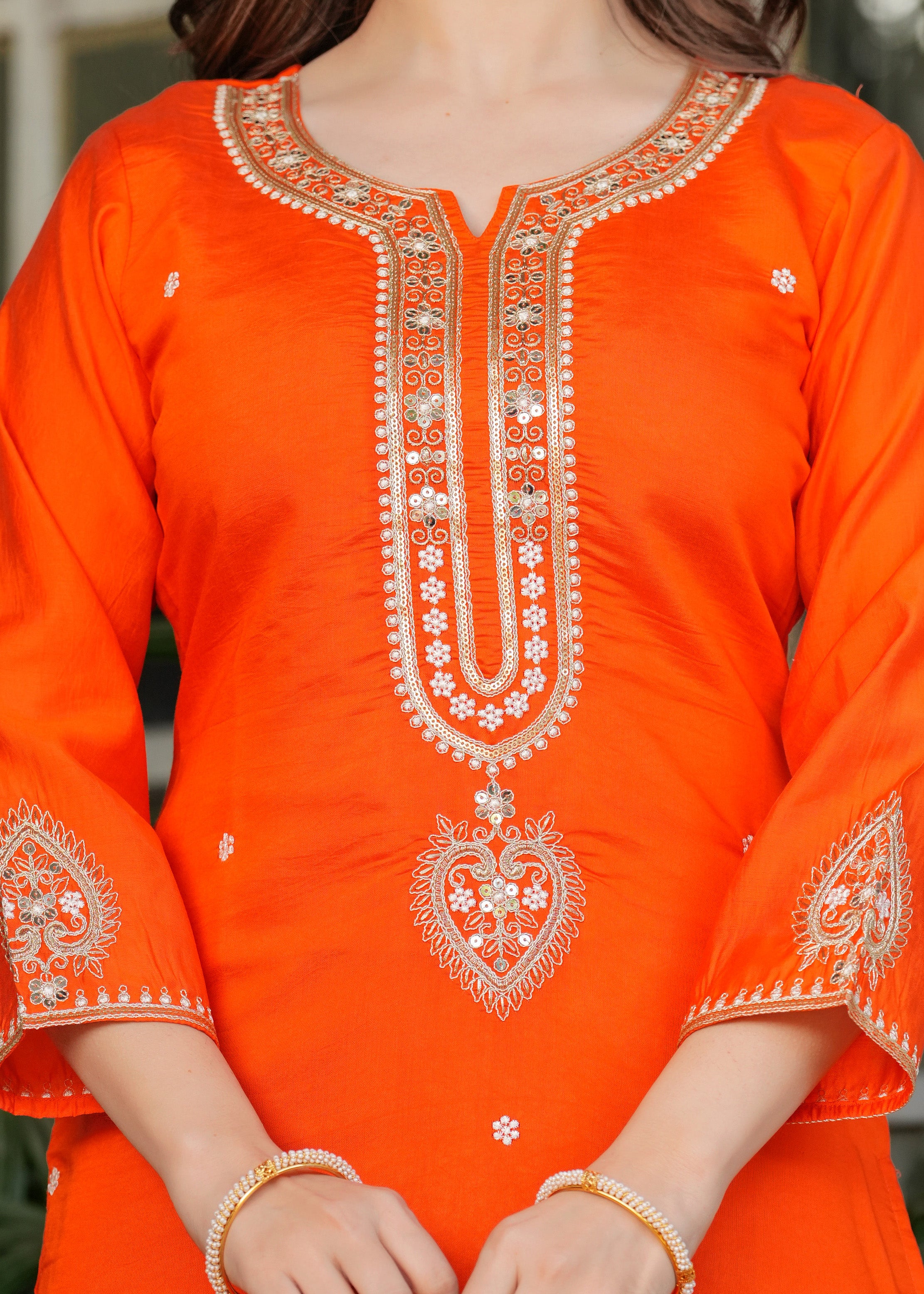 Detail of orange Viscose Chanderi kurta with gold and silver embroidery, sequins on neckline