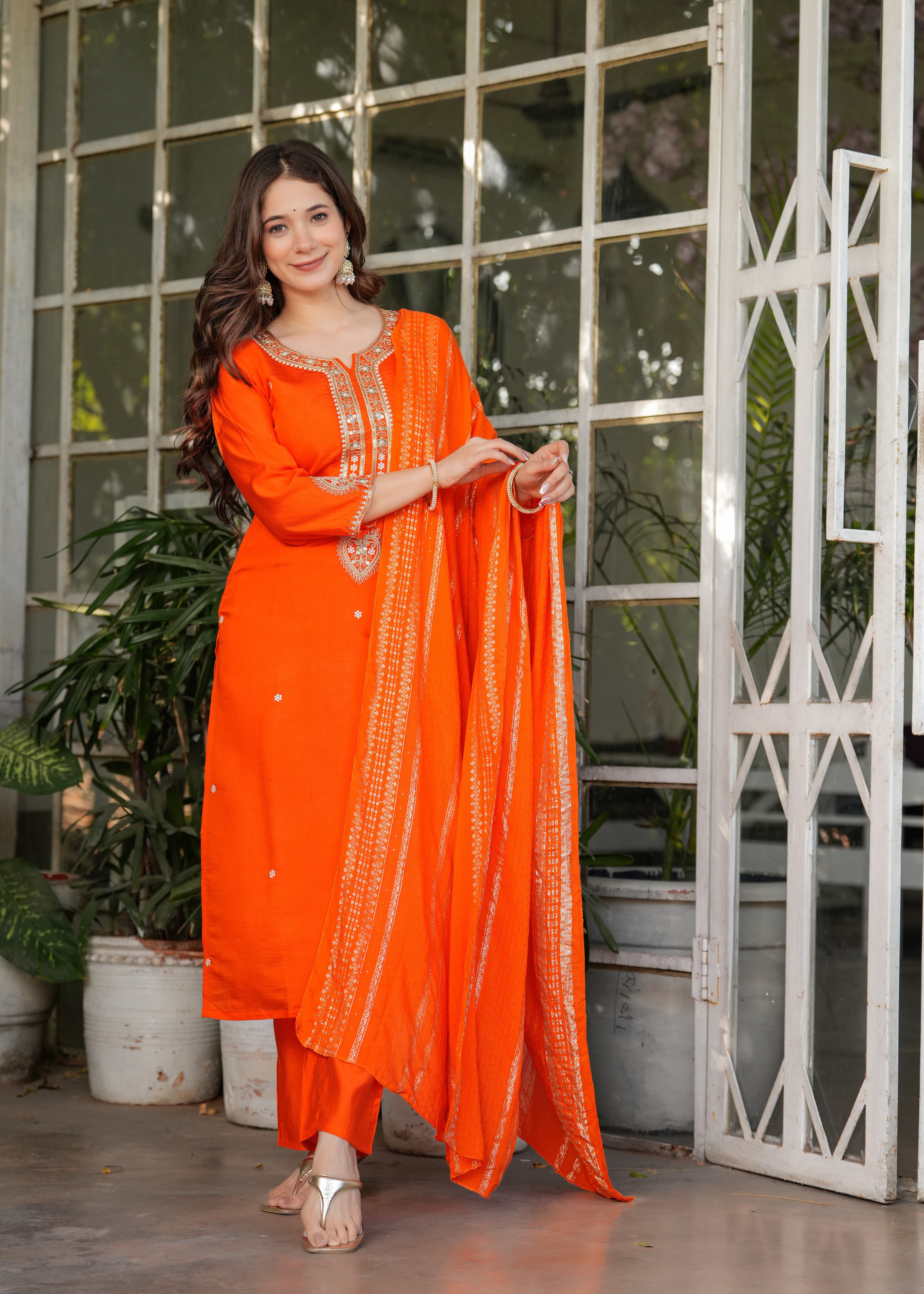 TRENDBUY woman gracefully holding orange jacquard dupatta, full length
