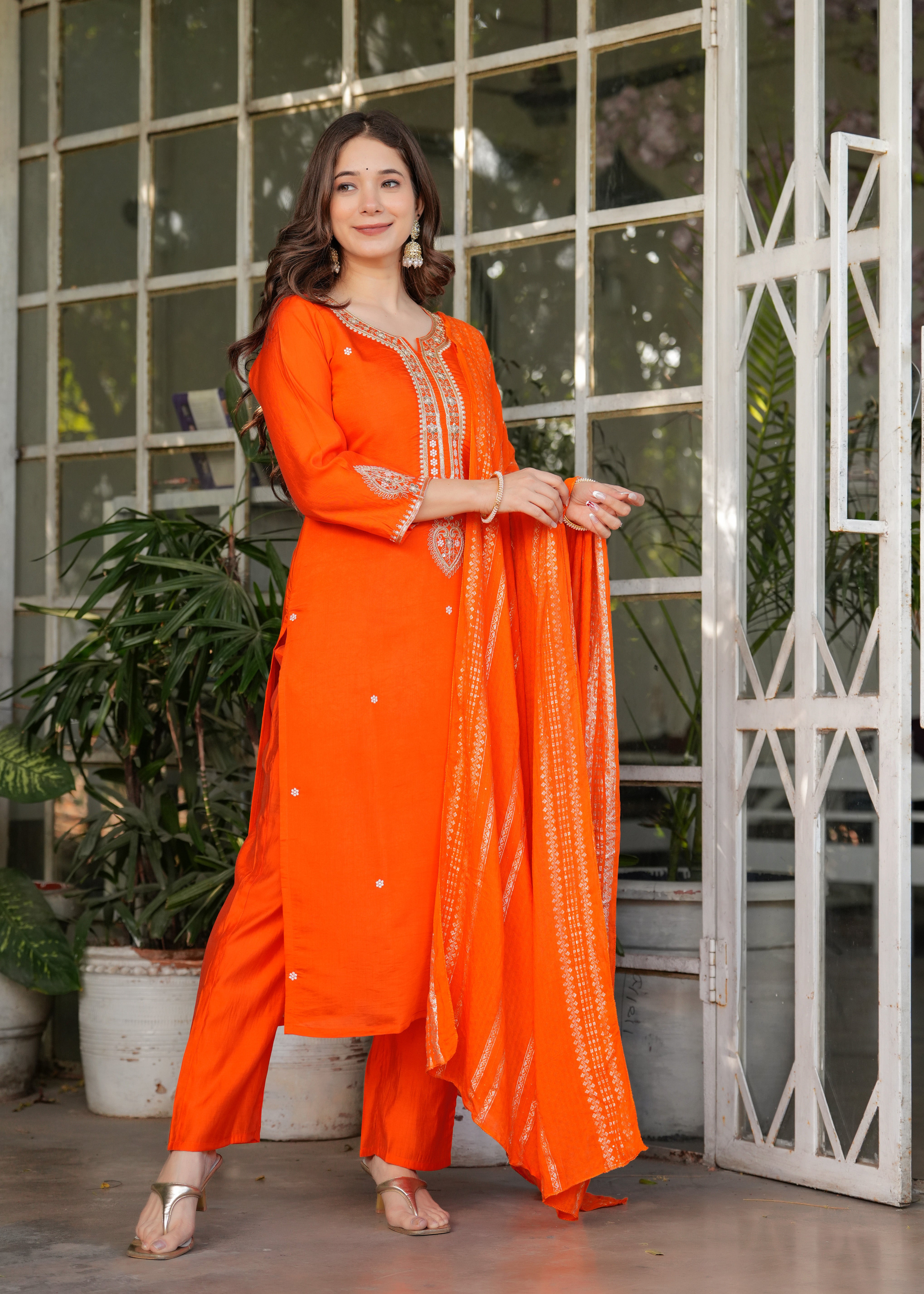Fashionable pose of TRENDBUY woman in orange embroidered kurta set, full length