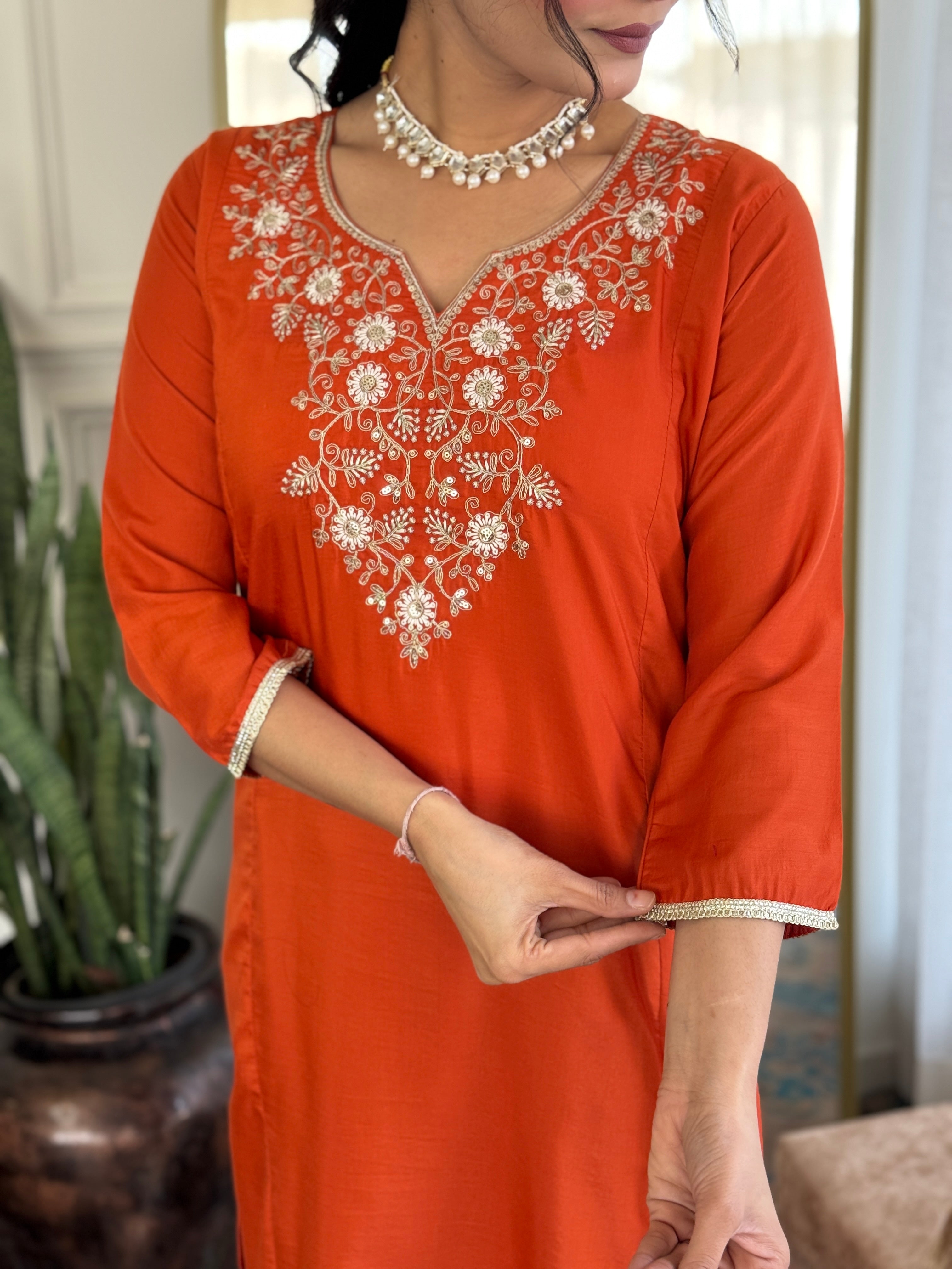 Detailed shot of the sleeve and neckline embroidery on the orange Viscose Chinon kurta, showing the delicate thread work and sequin accents.