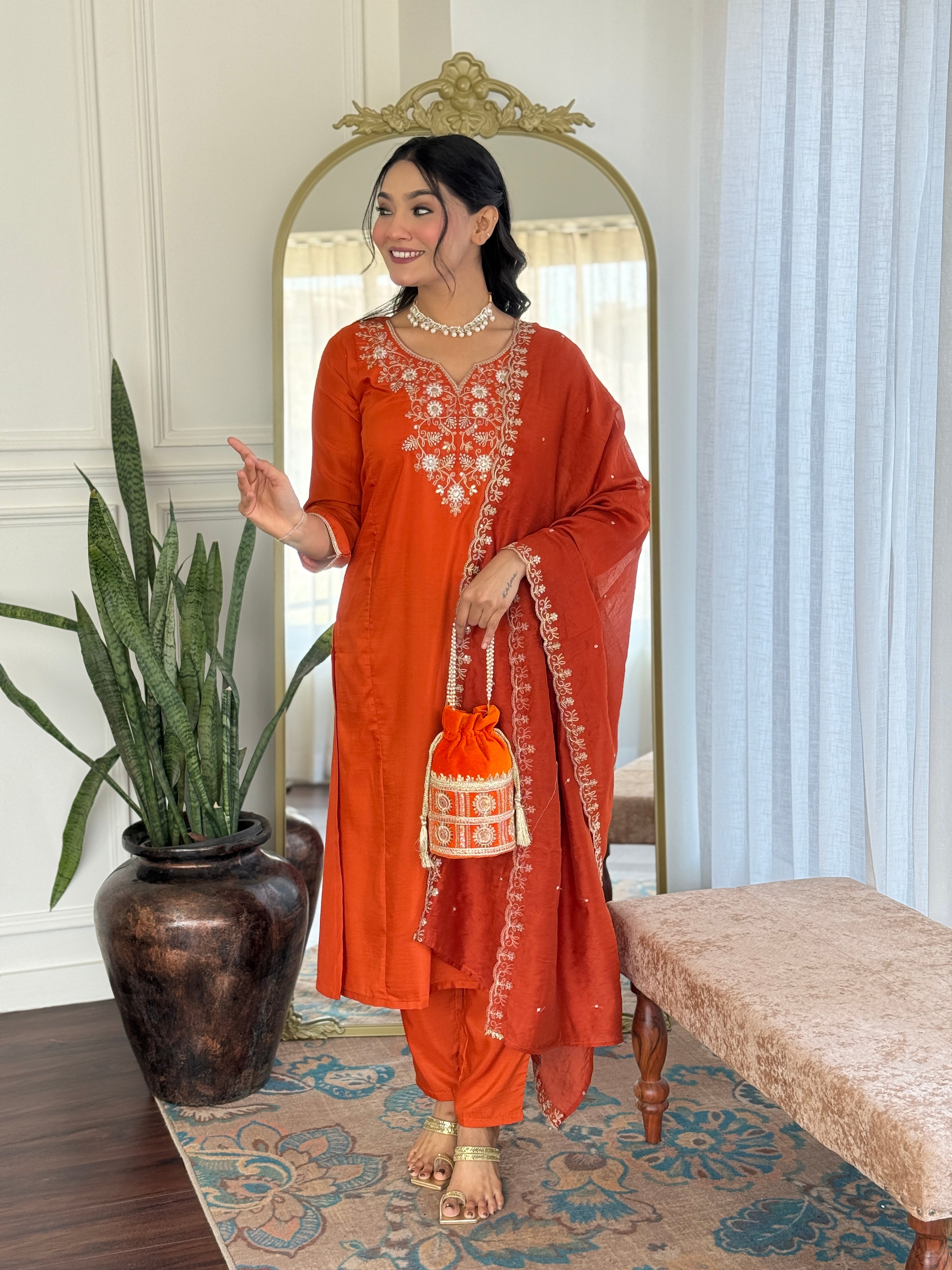 Smiling TRENDBUY model showcasing the vibrant orange embroidered kurta set, highlighting the graceful silhouette and comfortable fit.