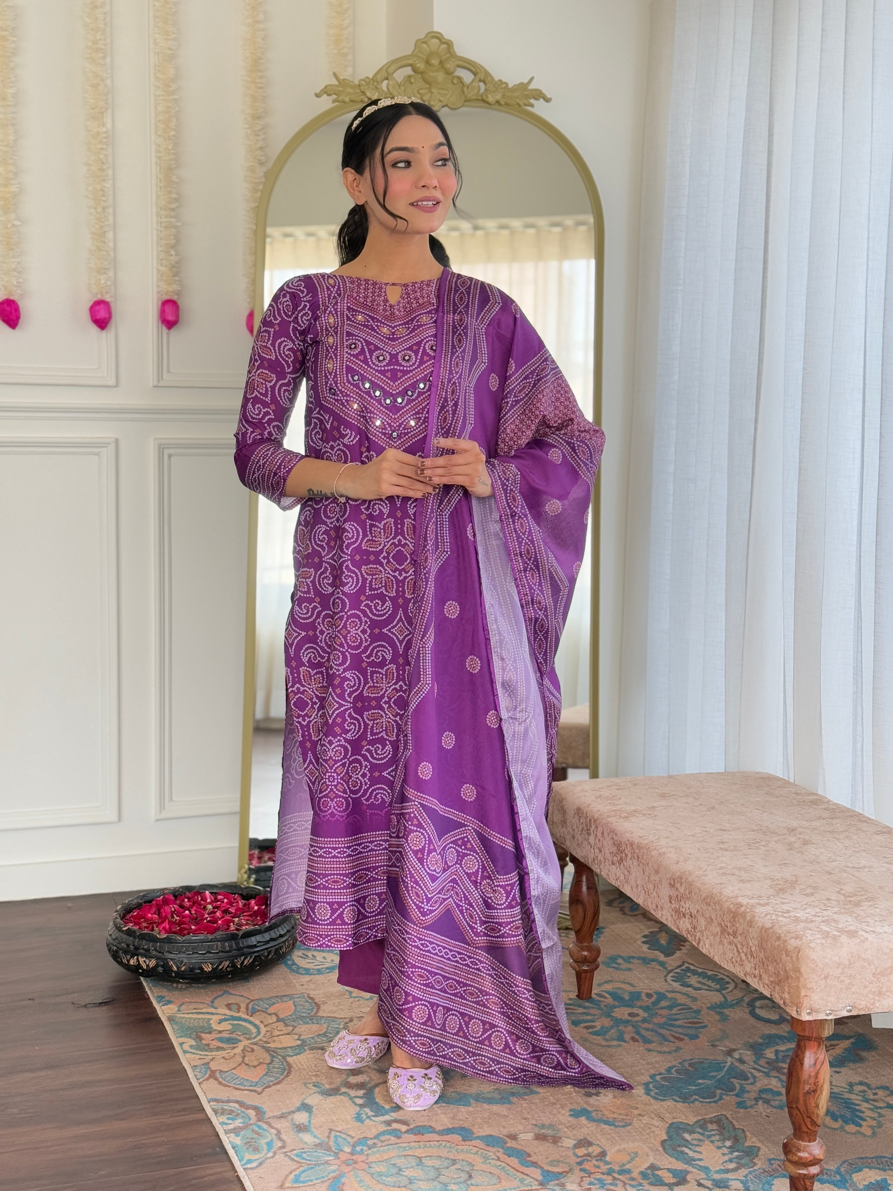 TRENDBUY model showcasing the purple hand mirrored kurti set from the front with a royal backdrop.