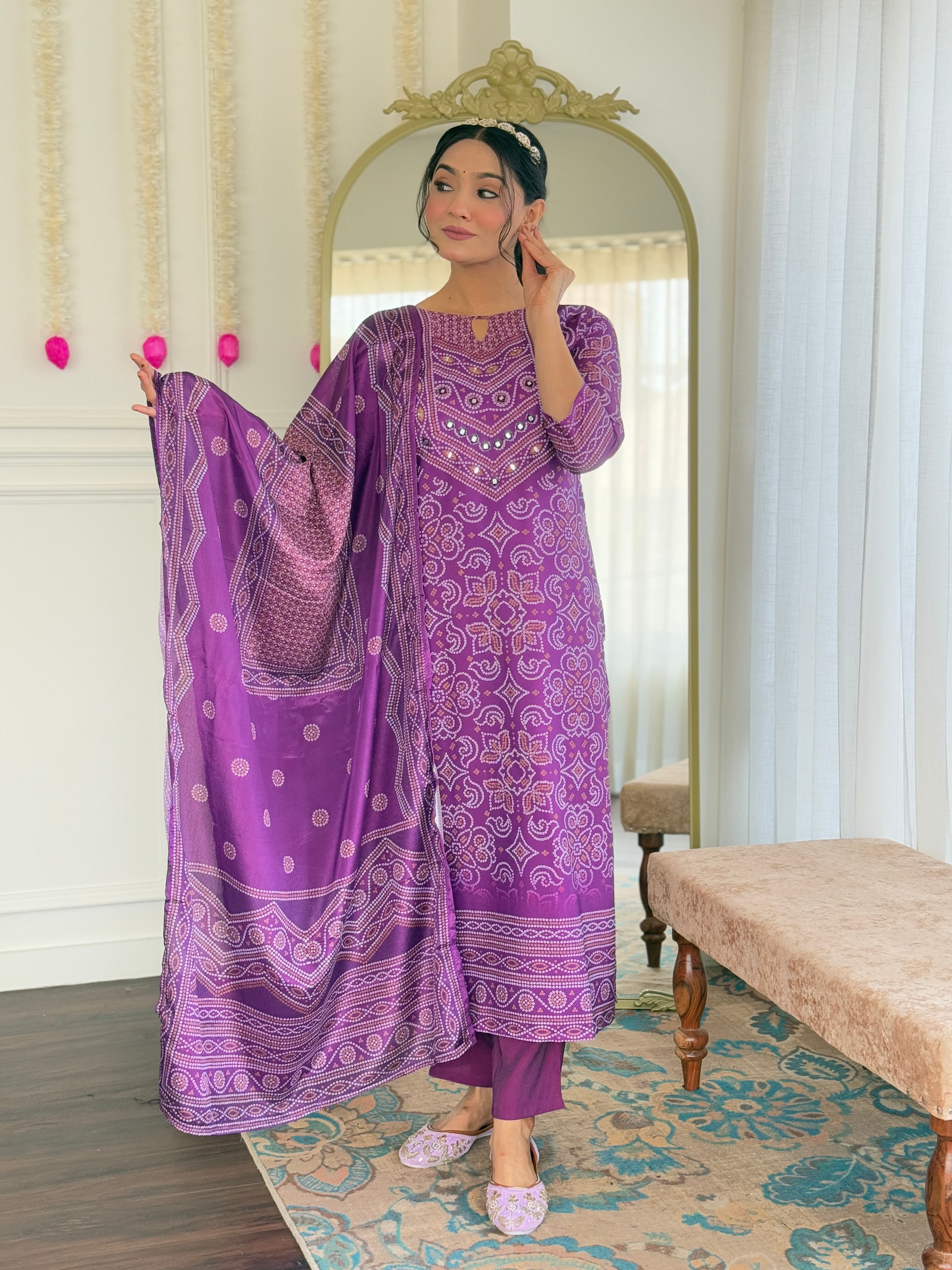 Model holding the flowing chinon dupatta, emphasizing the traditional print and soft fabric of the purple kurti set.
