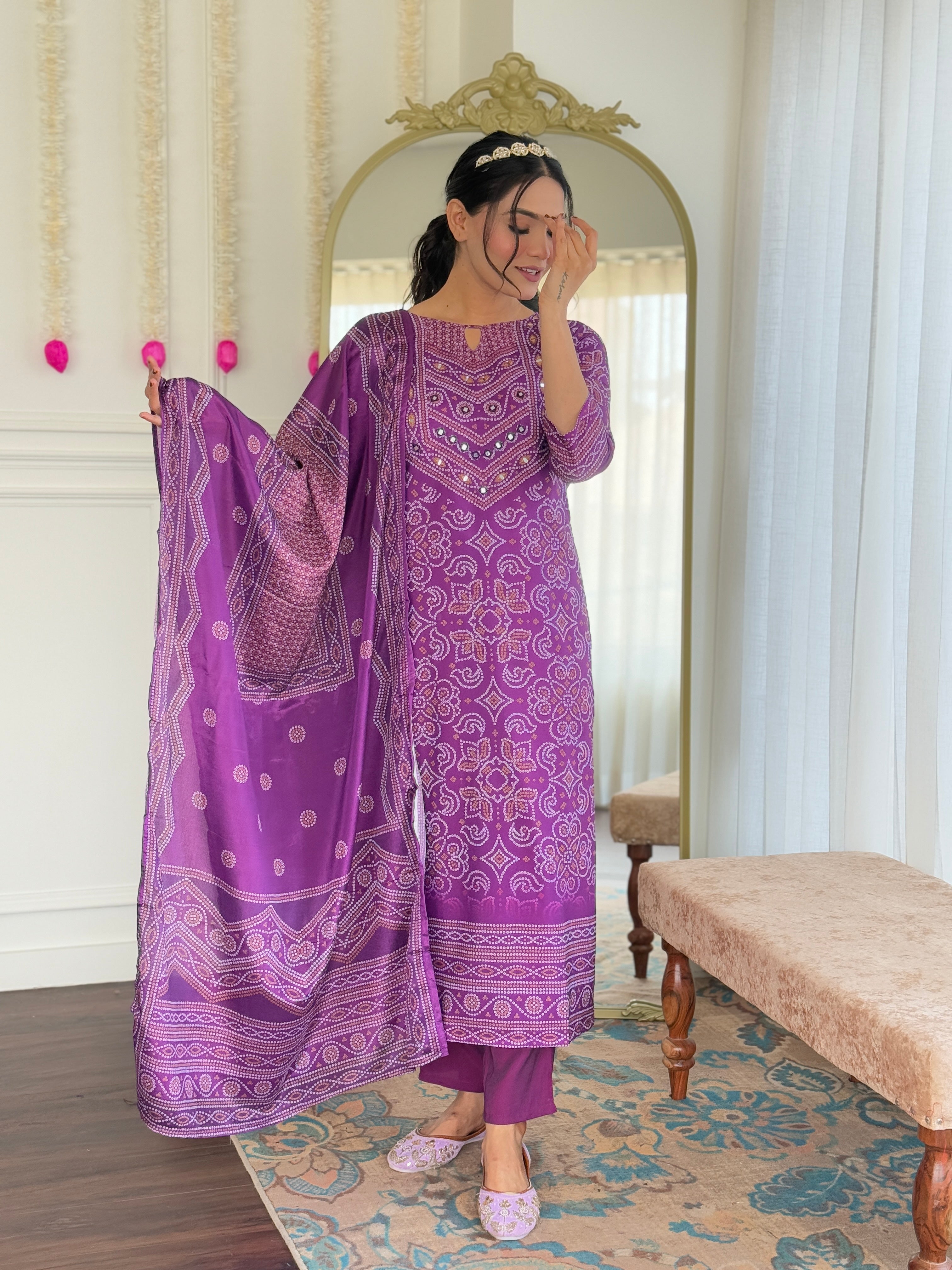 Close-up of model's serene expression, featuring the intricate hand mirror work on the purple kurti's neckline.