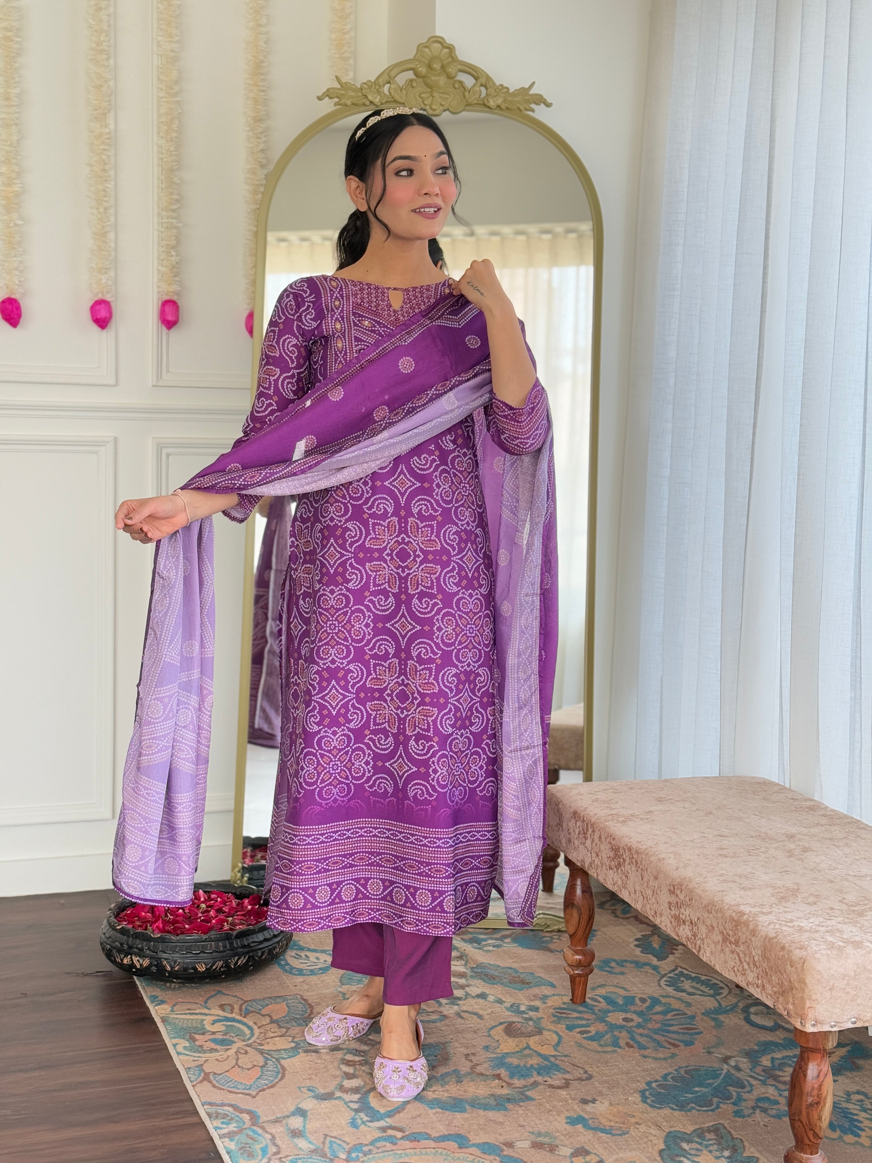 Model gracefully draping the purple dupatta over her shoulder, showing the complete look of the ethnic set.