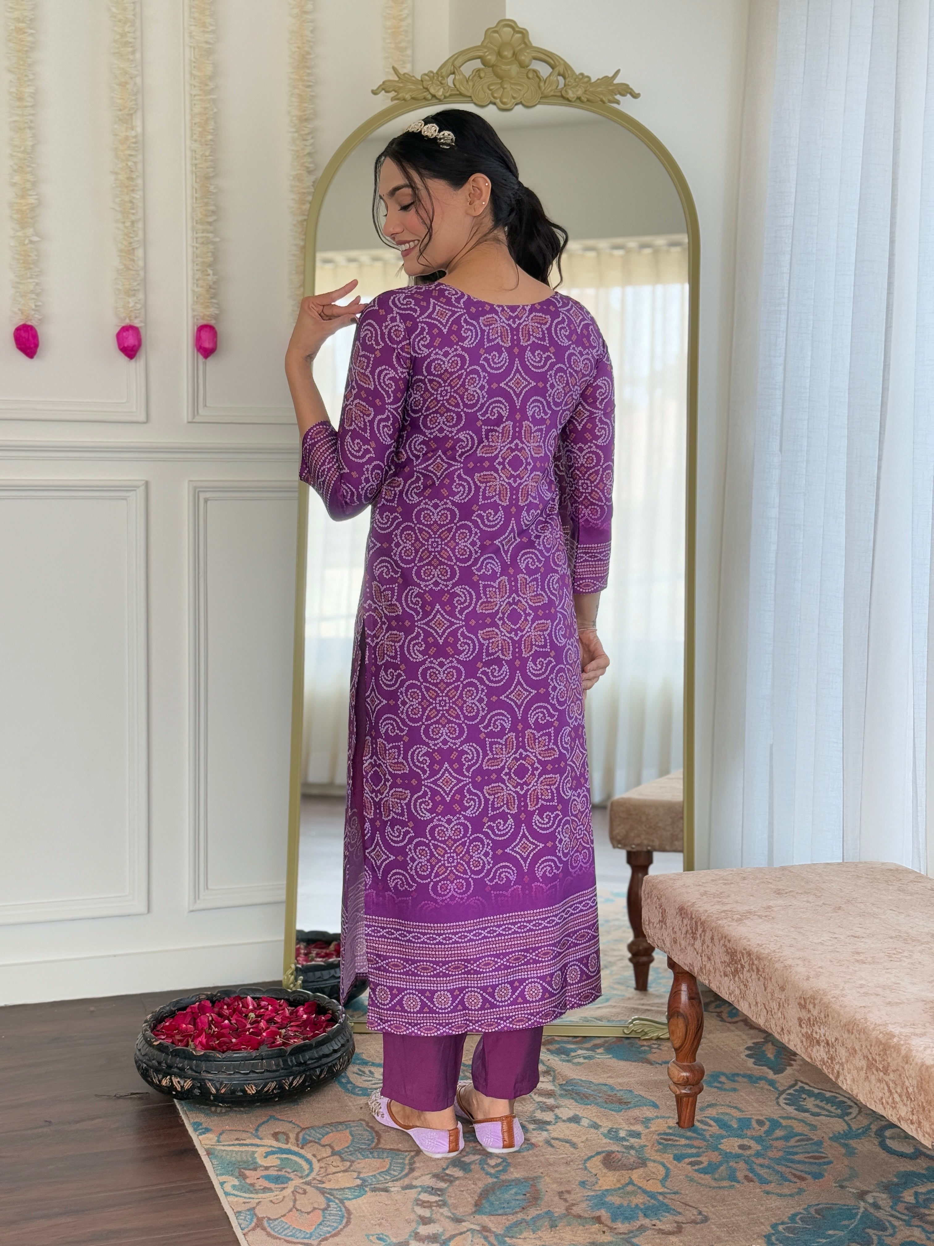 Rear view of the model showcasing the back design and comfortable fit of the purple kurti.
