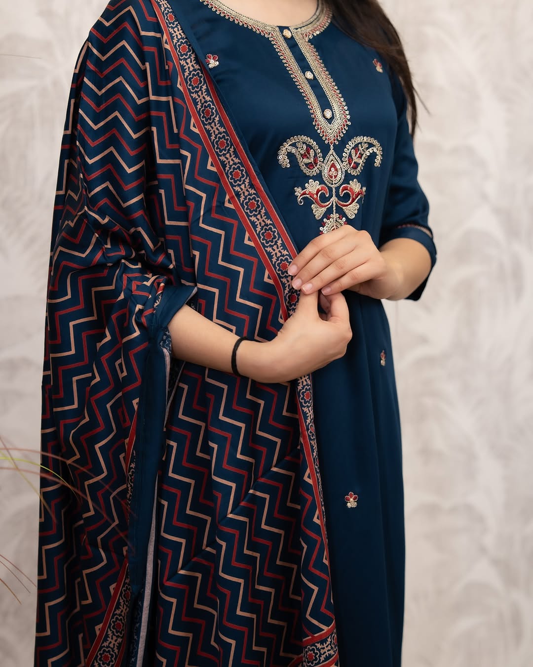 Detailed view of the hand-printed embroidery on the deep blue Chanderi Silk kurta and the geometric pattern on the muslin dupatta