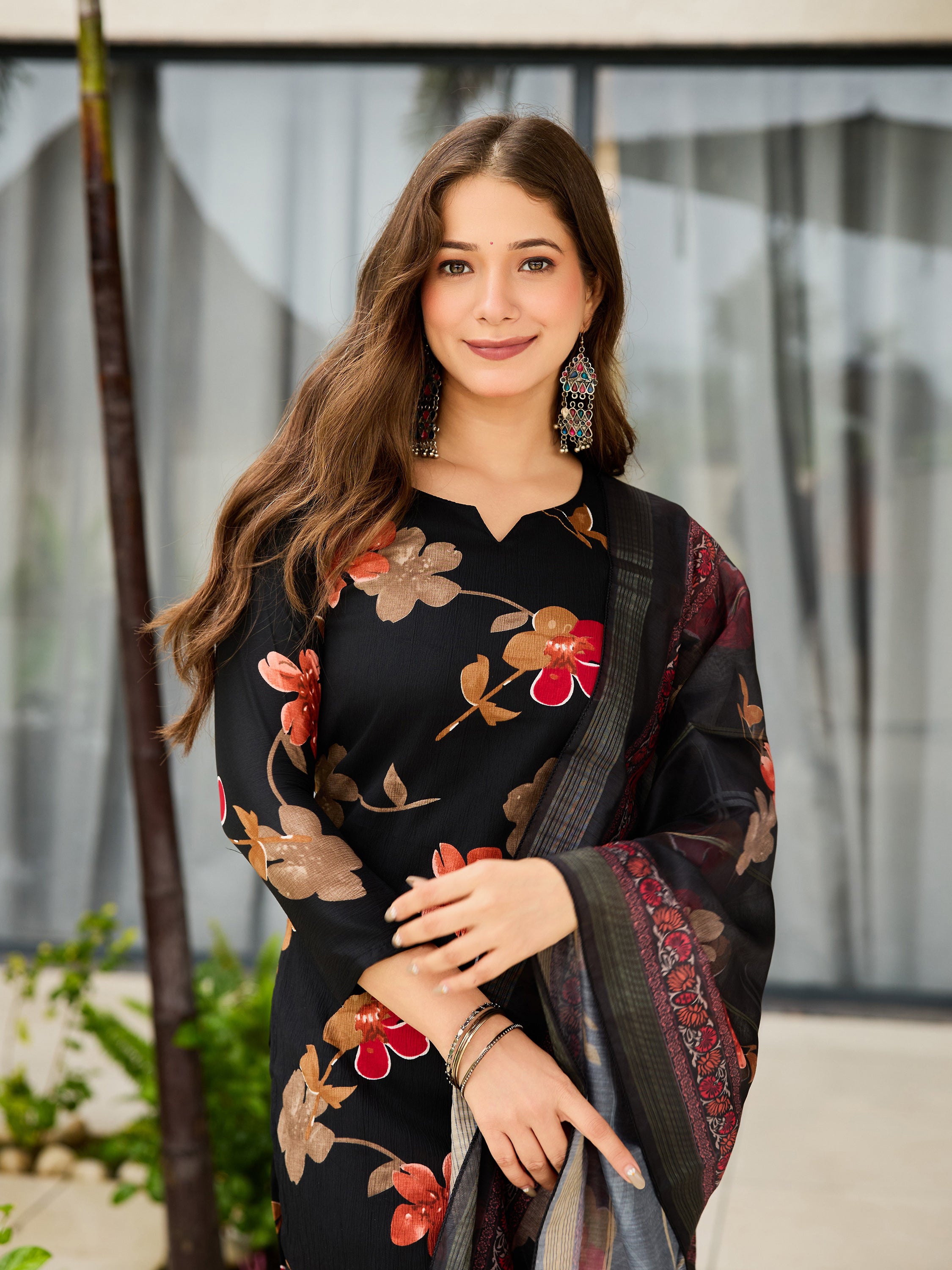 Close-up of model showcasing TRENDBUY black floral kurti with full sleeves and designer jhumka earrings