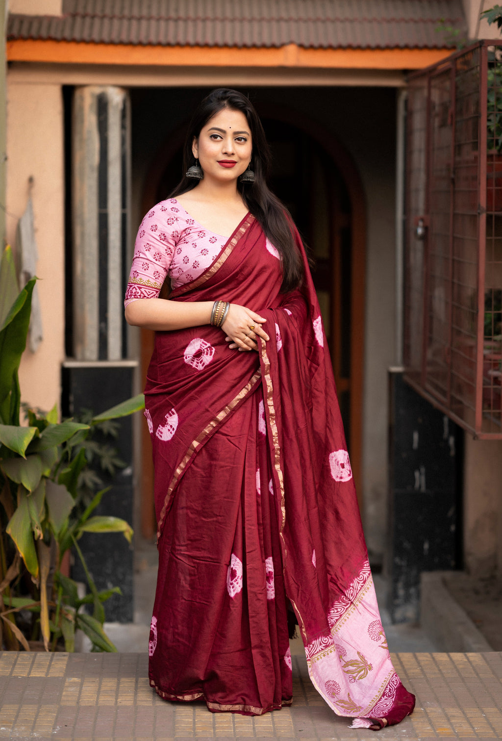 Maroon Chanderi Cotton Shibori print sari with a unique texture & pattern, elegantly draped on a model