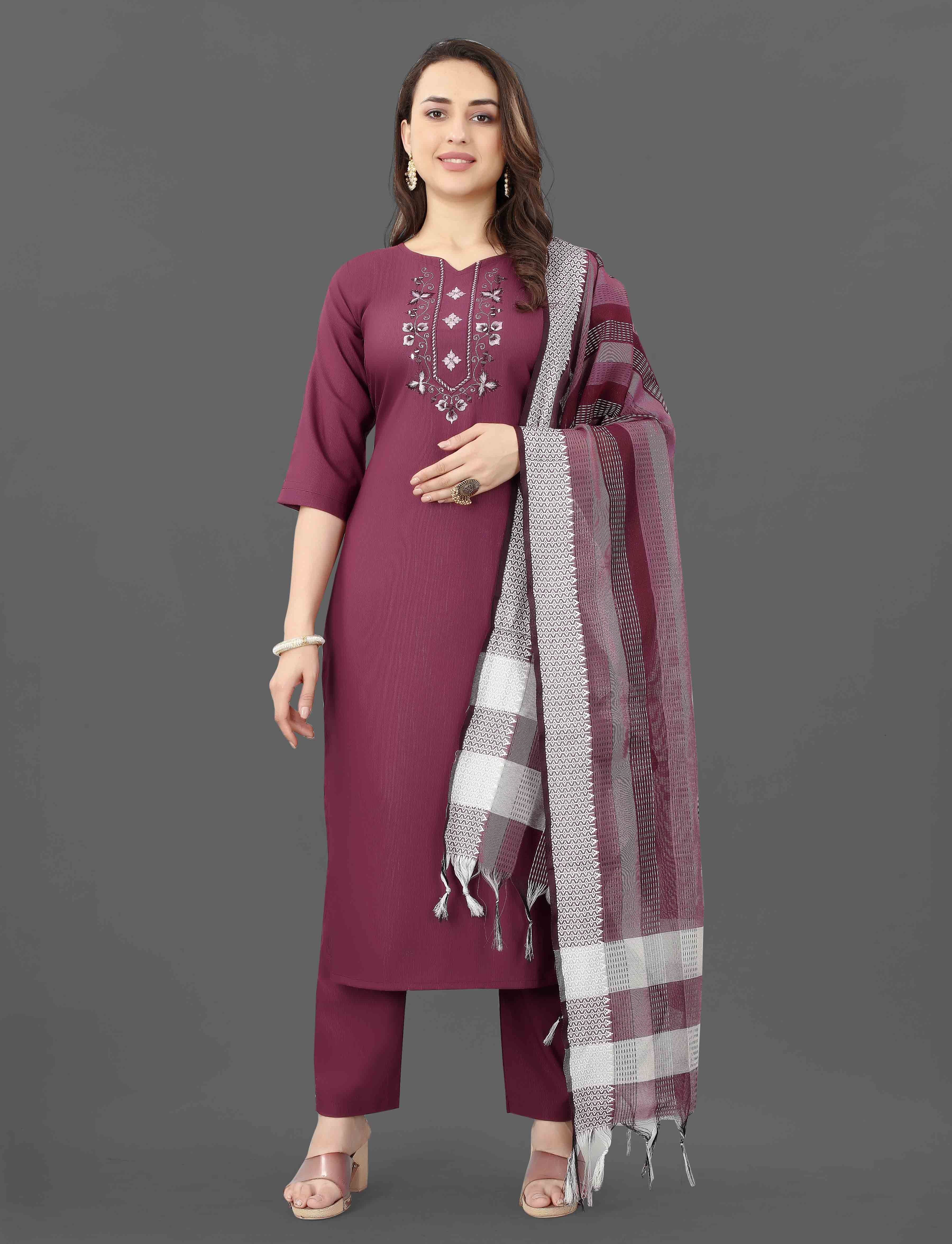 Woman confidently posing in a maroon TRENDBUY Mohini cotton blend kurti set with intricate embroidery and mirror work.