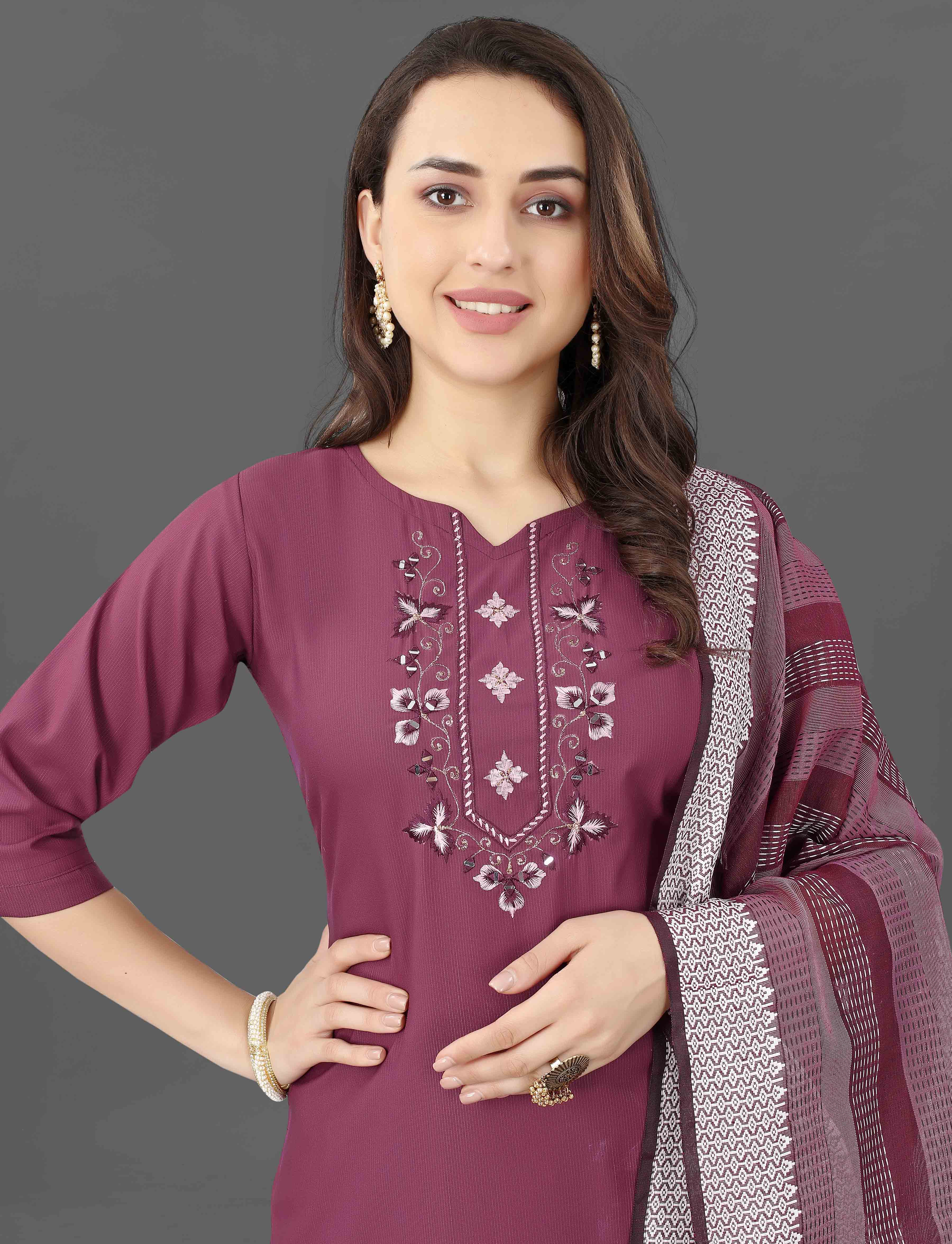 Detailed shot of the V-neckline of the maroon kurti, revealing the delicate embroidery and shimmering mirror work.
