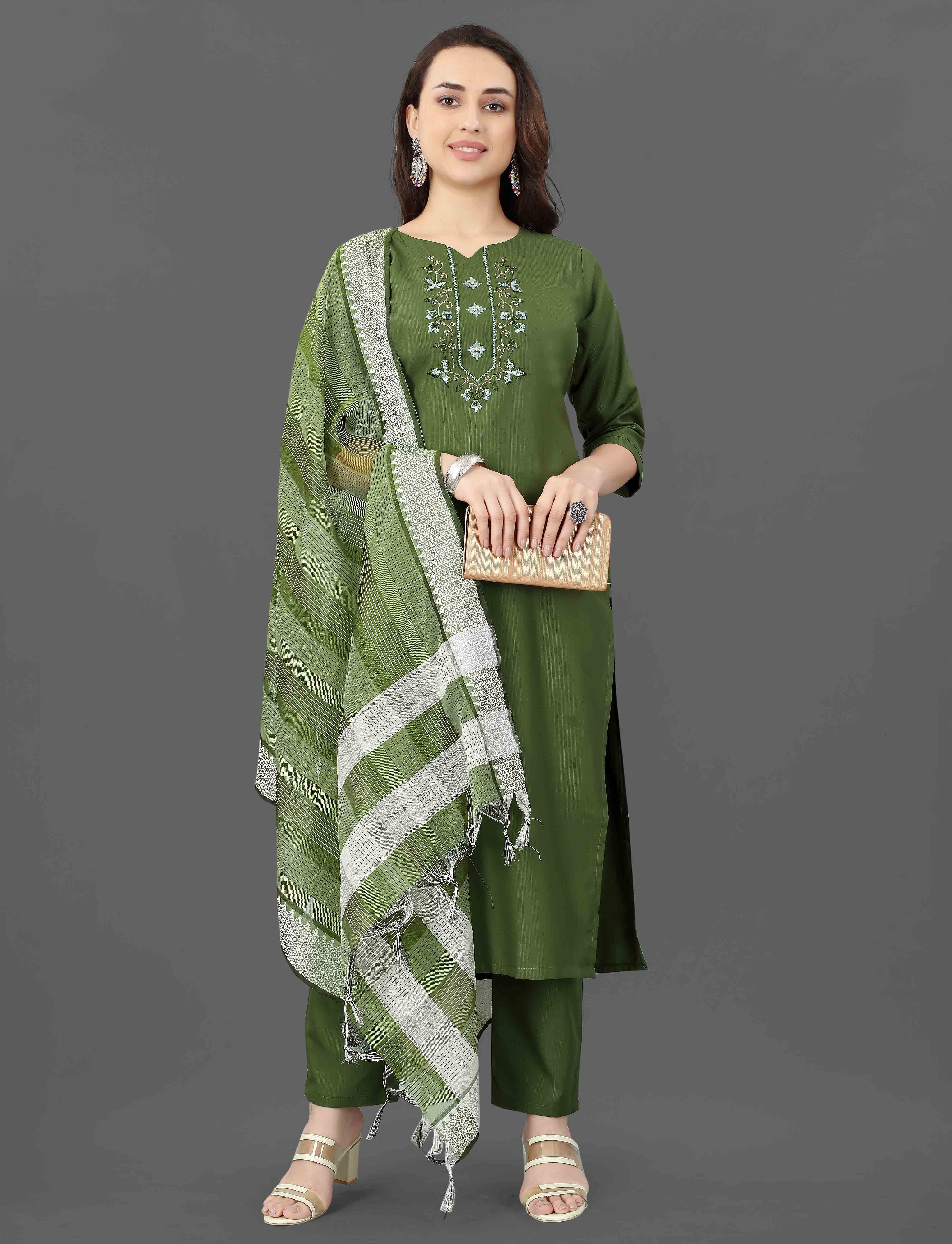 Woman confidently posing in a green TRENDBUY Mohini cotton blend kurti set with intricate embroidery and mirror work.