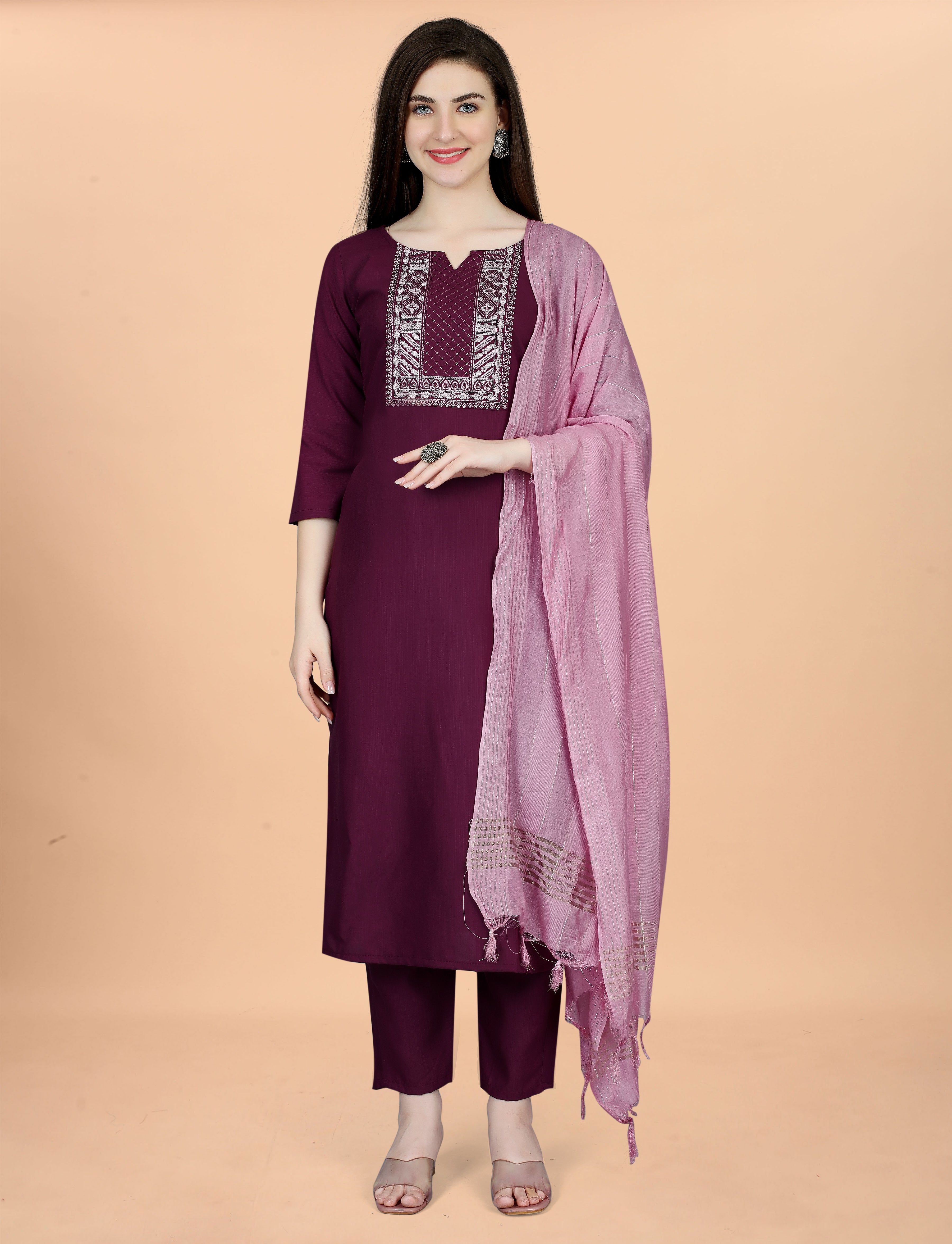 Front view of a smiling woman in a plum embroidered cotton blend kurti, comfortable pant, and an elegant pink chanderi dupatta.