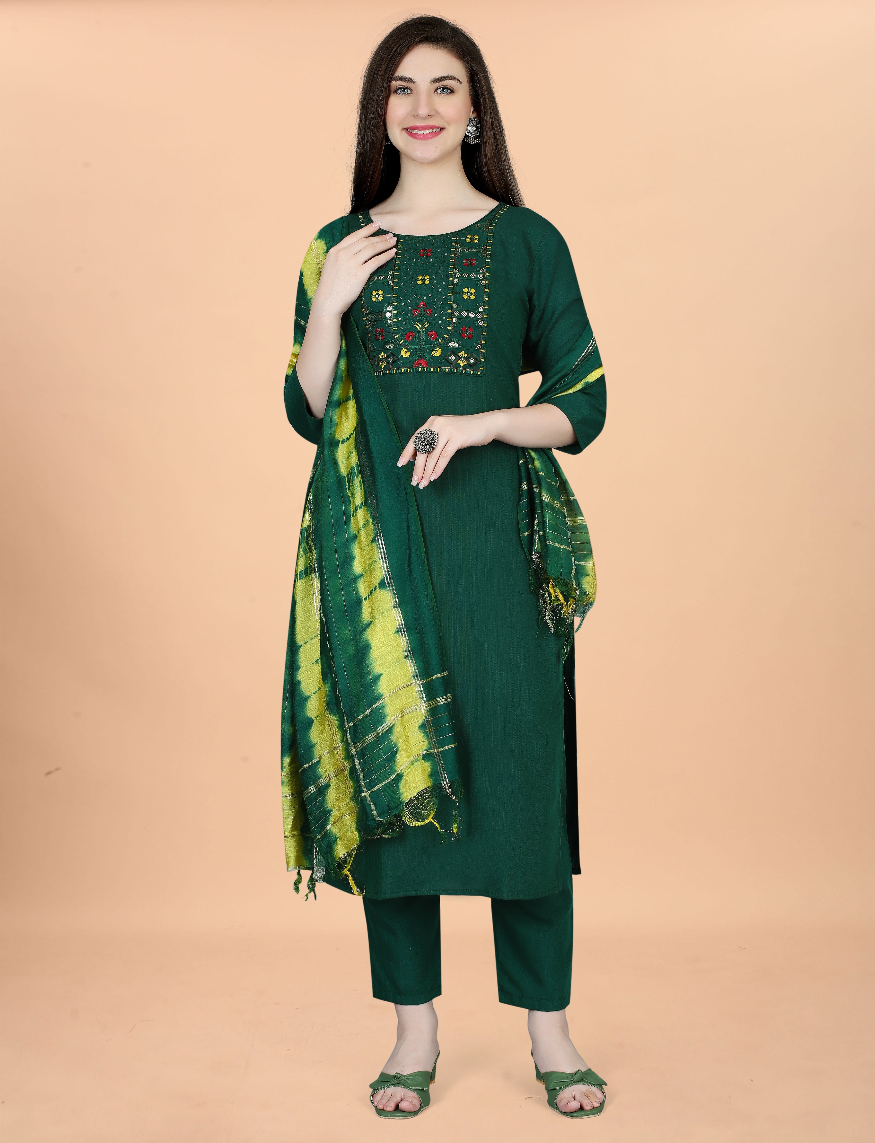 Full front view of a smiling woman in a deep green embroidered cotton blend kurta set with a vibrant tie-dye Chanderi dupatta.