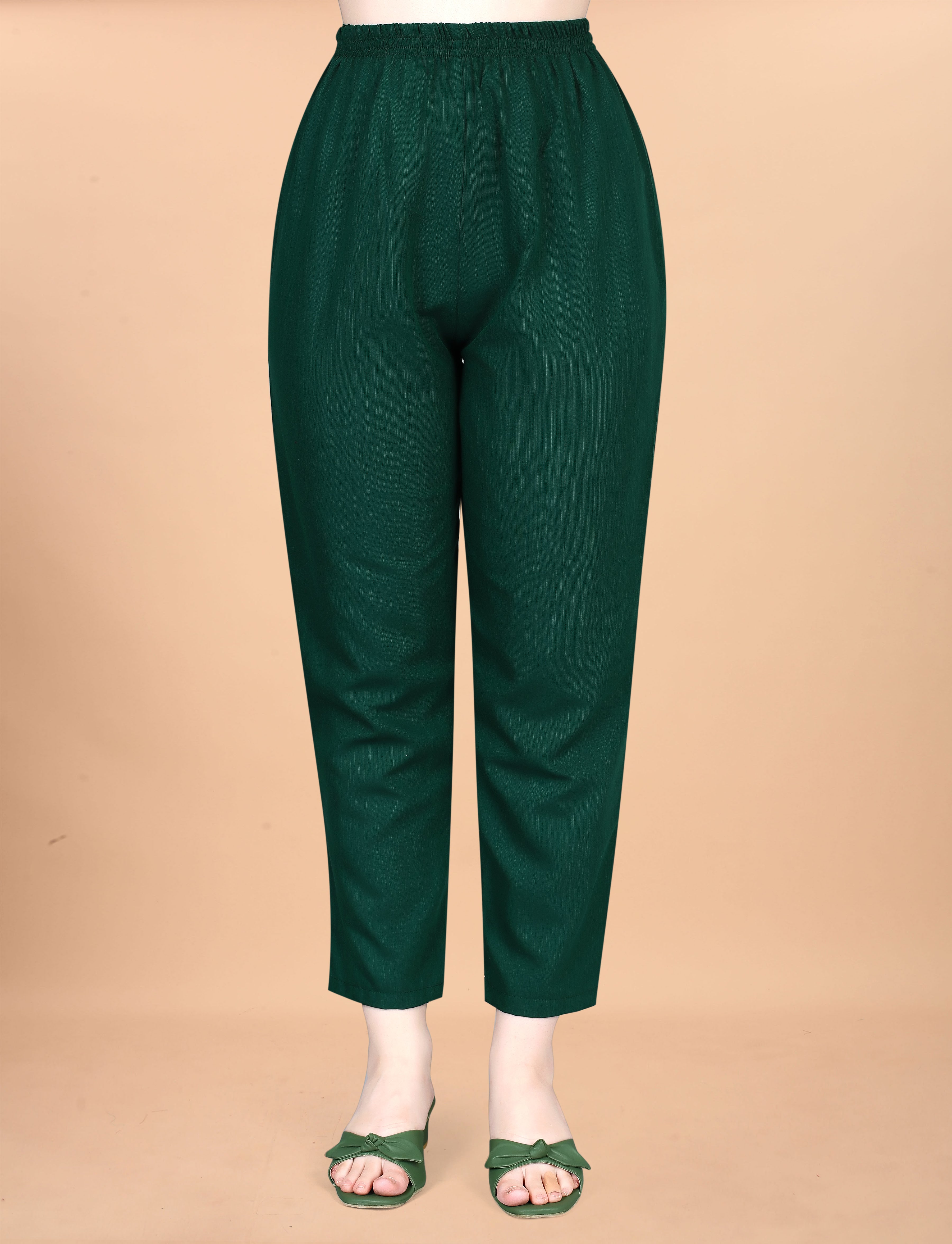 Close-up of deep green cotton blend women's pant with elastic waist on a mannequin.