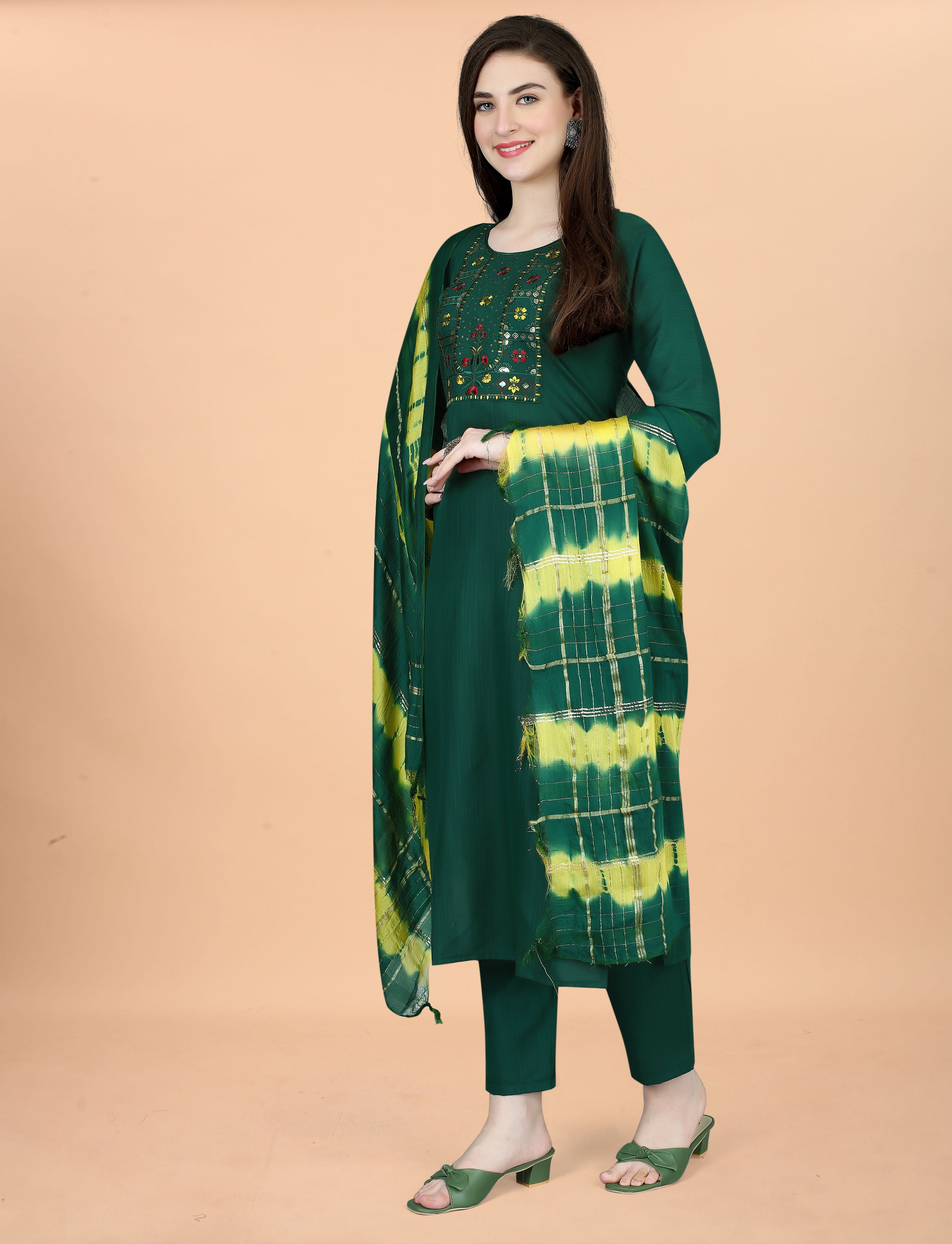 Woman showcasing a deep green embroidered kurta set with a stylish tie-dye dupatta, front pose.