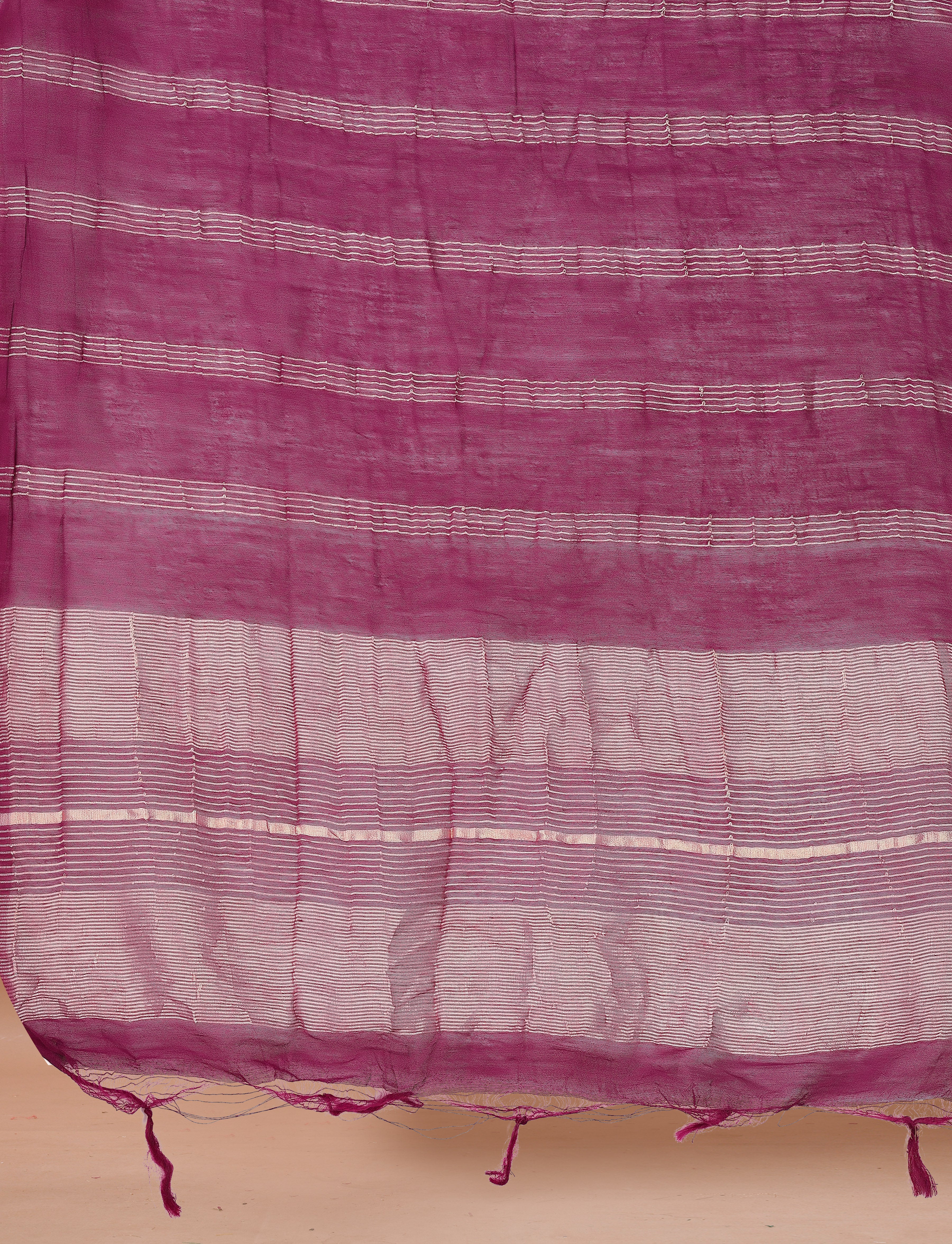 Close-up of a magenta Chanderi dupatta with delicate horizontal stripe patterns and tassels.