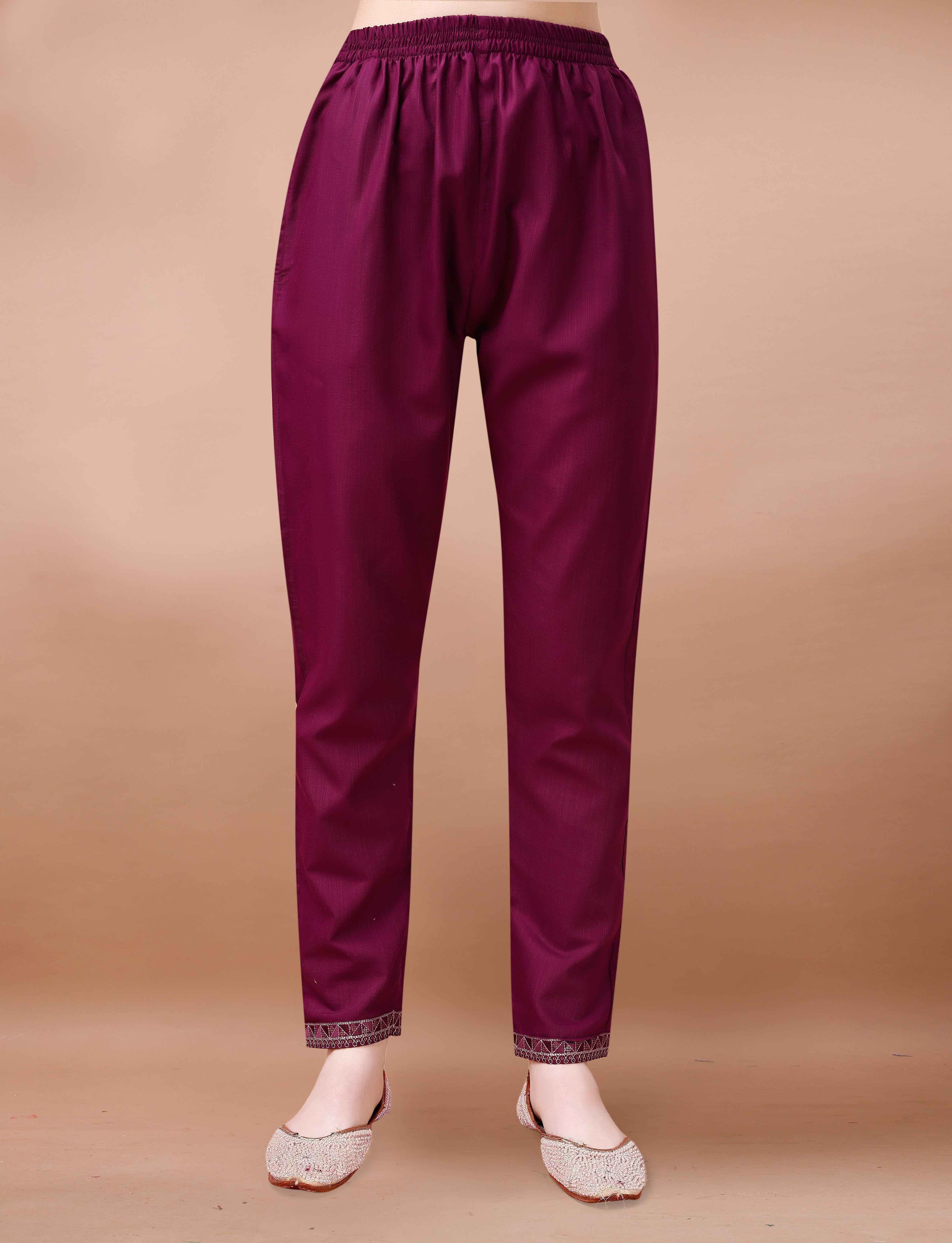 Mannequin displaying maroon cotton blend trousers with intricate geometric embroidery on the cuffs.