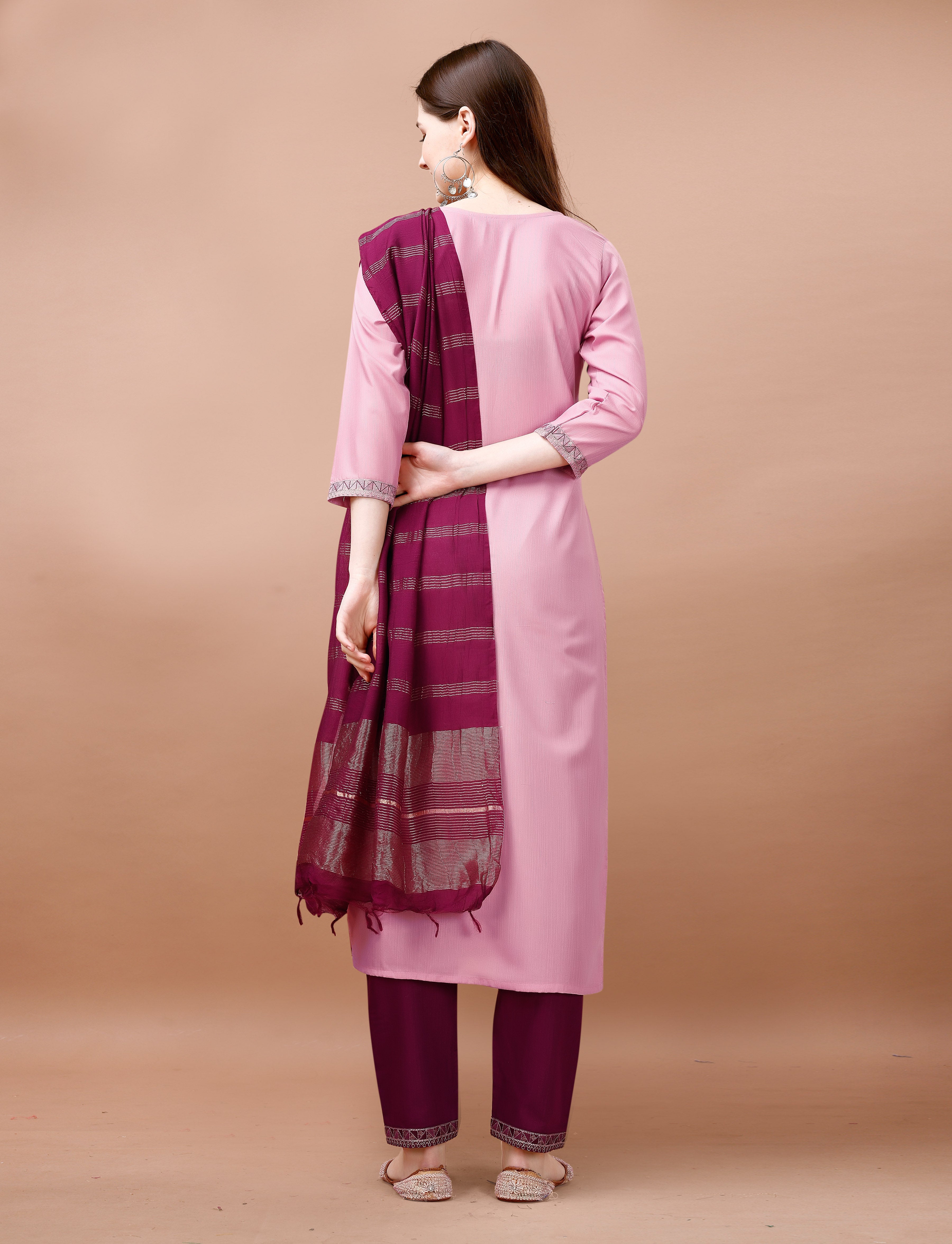 Rear view of a woman showcasing a blush pink embroidered kurta set with a maroon Chanderi dupatta draped over her shoulder.