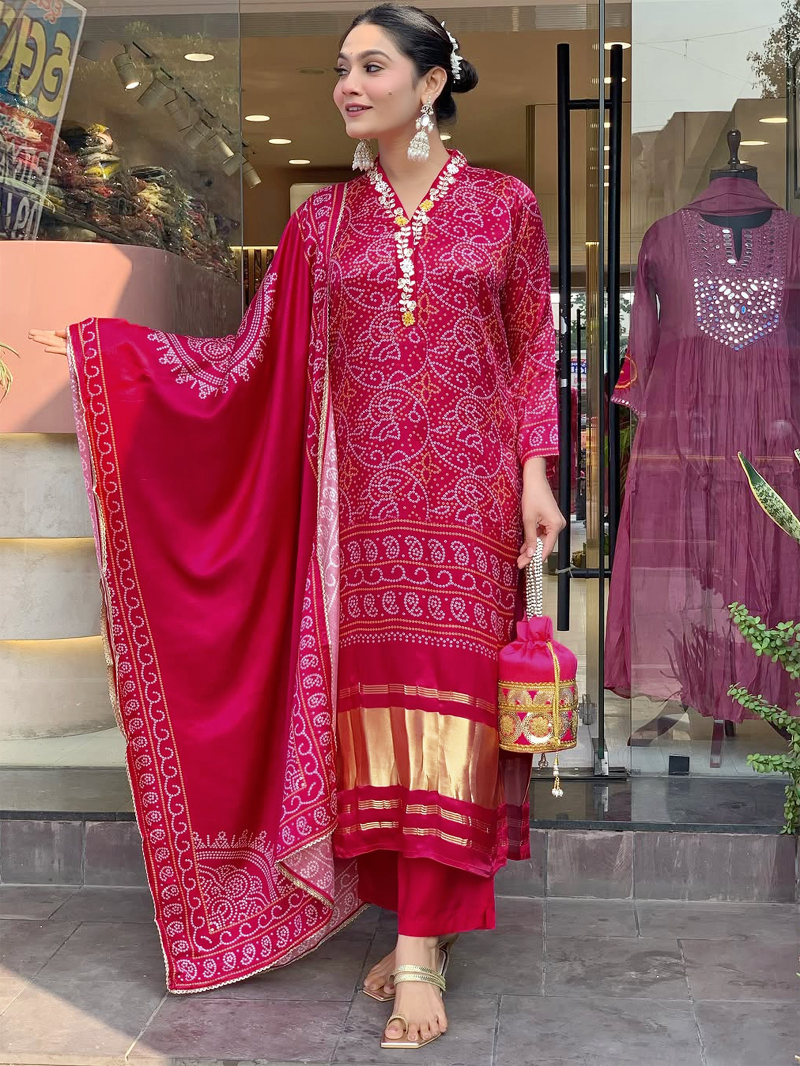 Full-length side profile of a woman smiling, showcasing the elegant drape of the magenta Chanderi cotton dupatta and the hand-printed Viscose Silk kurti with gold accents.