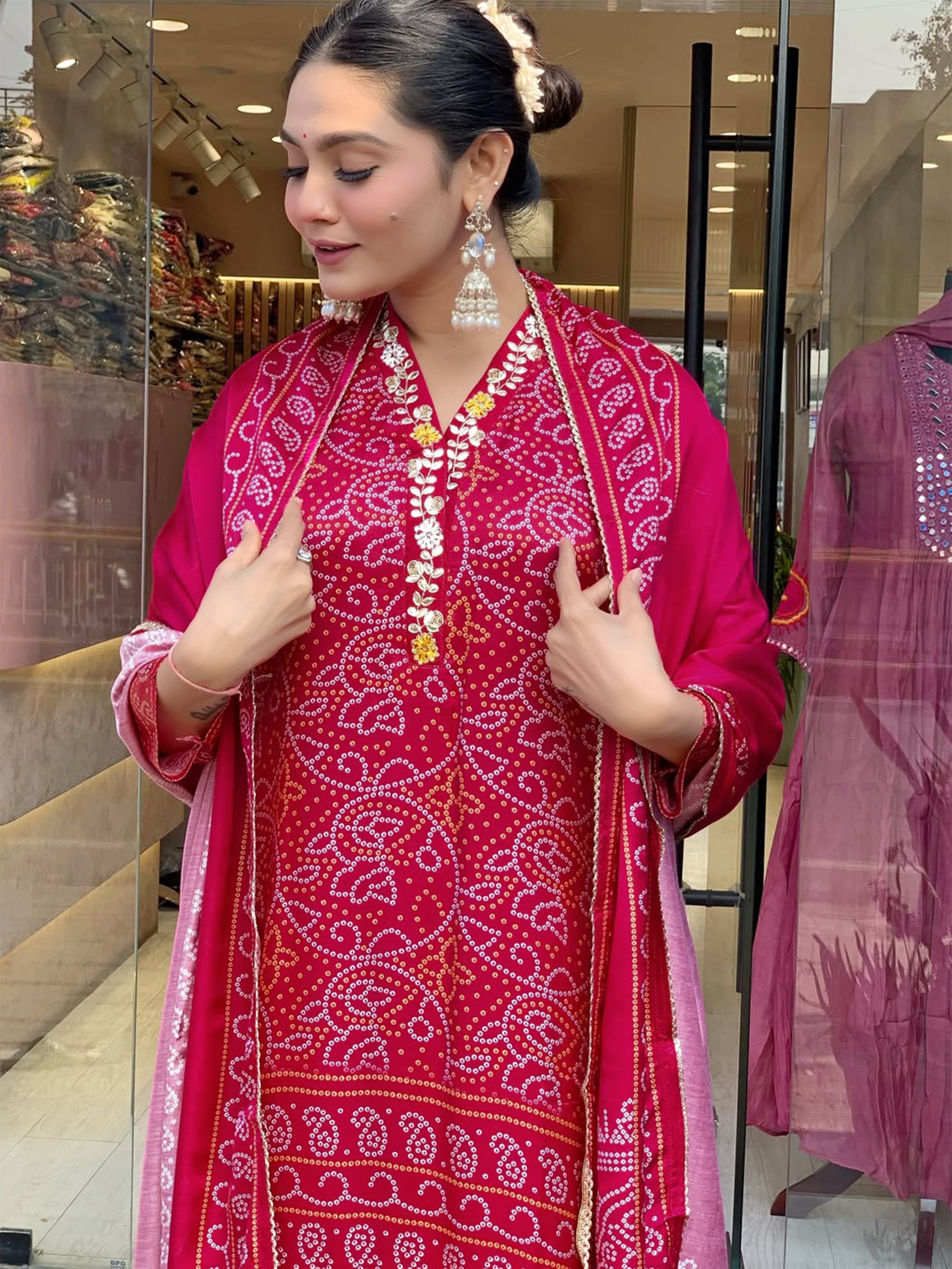 Woman adjusting the magenta Chanderi cotton dupatta over her hand-printed Viscose Silk kurti, highlighting the neckline embroidery and the overall fit.