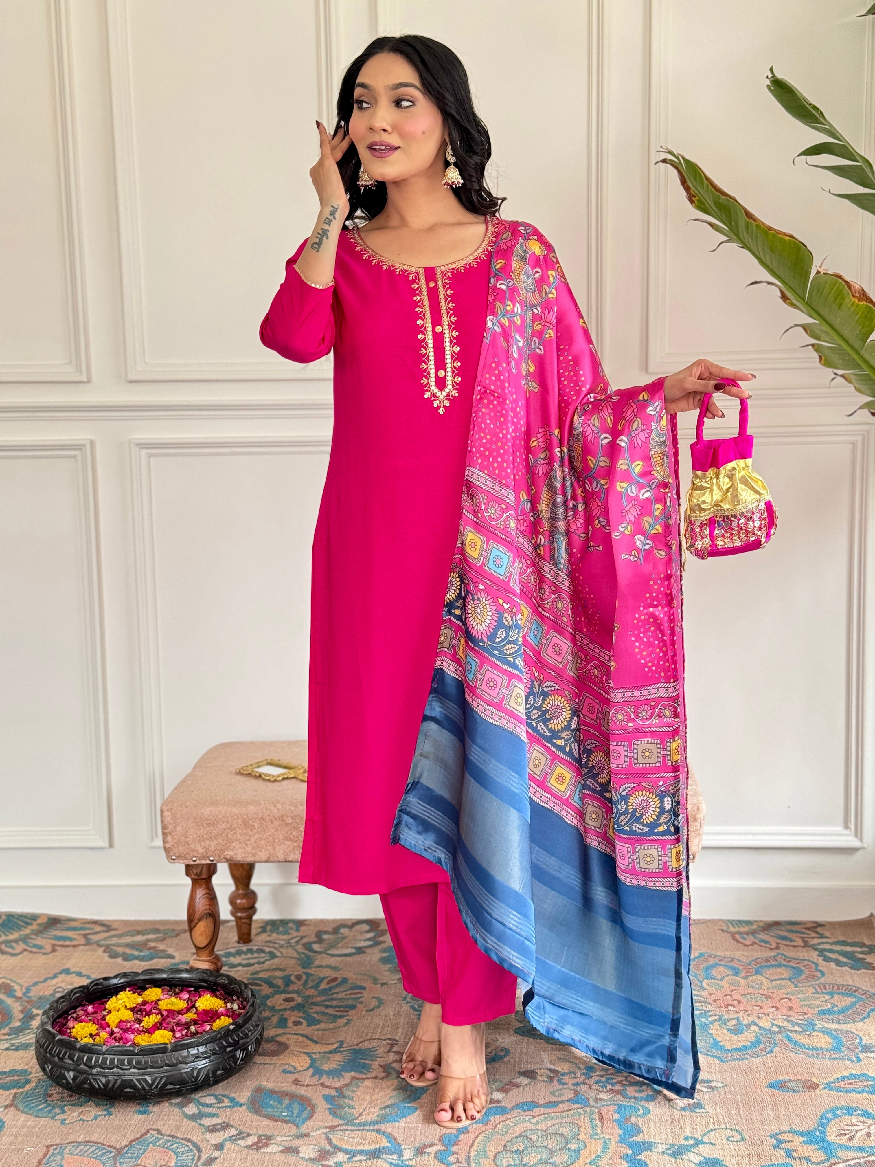 Model posing with Gajri embroidered kurti and vibrant printed dupatta, holding a matching potli bag.