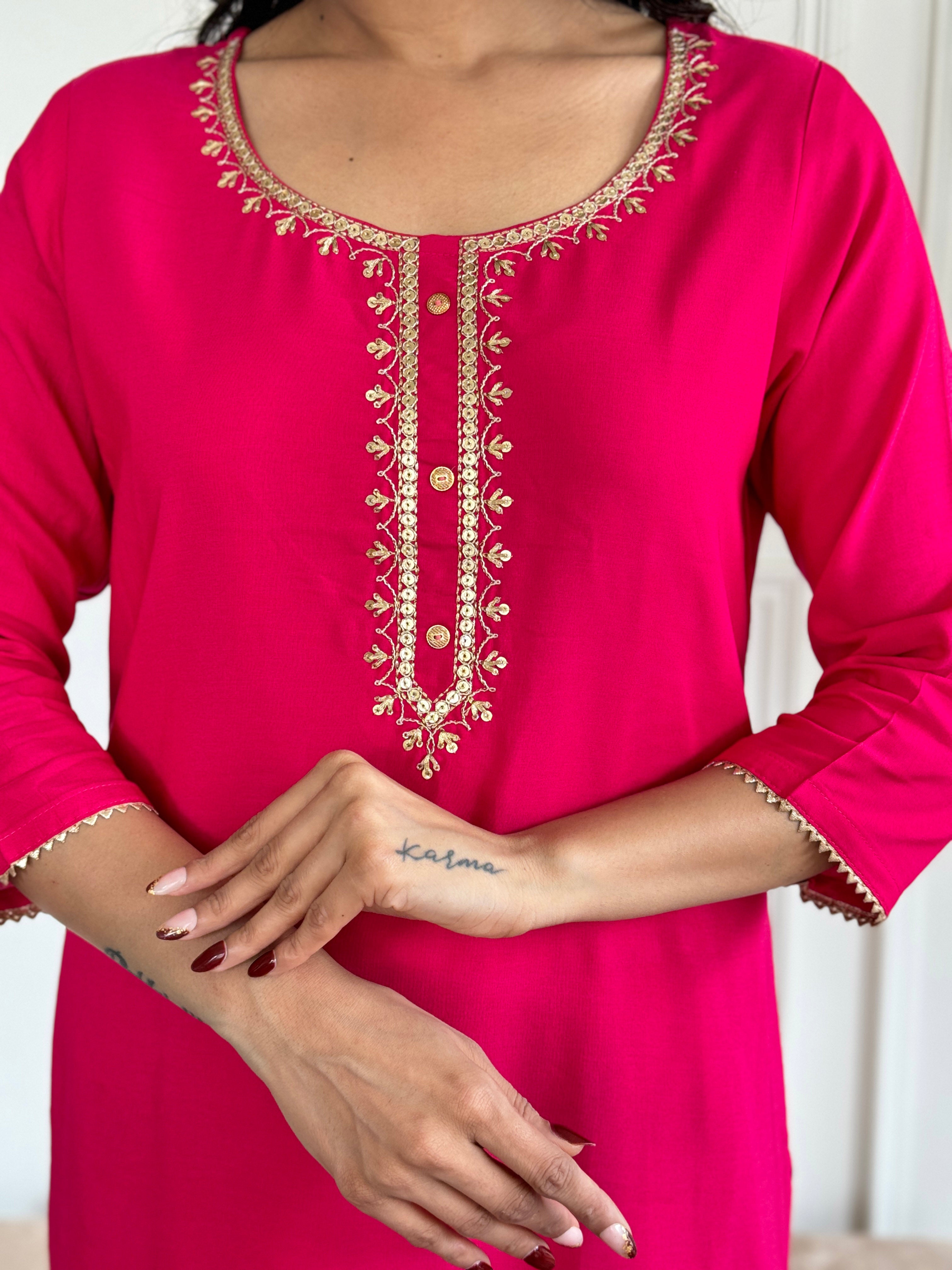 Close-up of the intricate gold embroidery on the round neckline of the Gajri kurti.