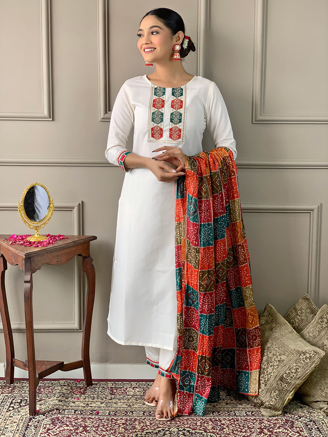 Model posing gracefully in TRENDBUY D488 Off-White embroidered Kurta Set with a vibrant multi-color silk blend dupatta draped over one shoulder.