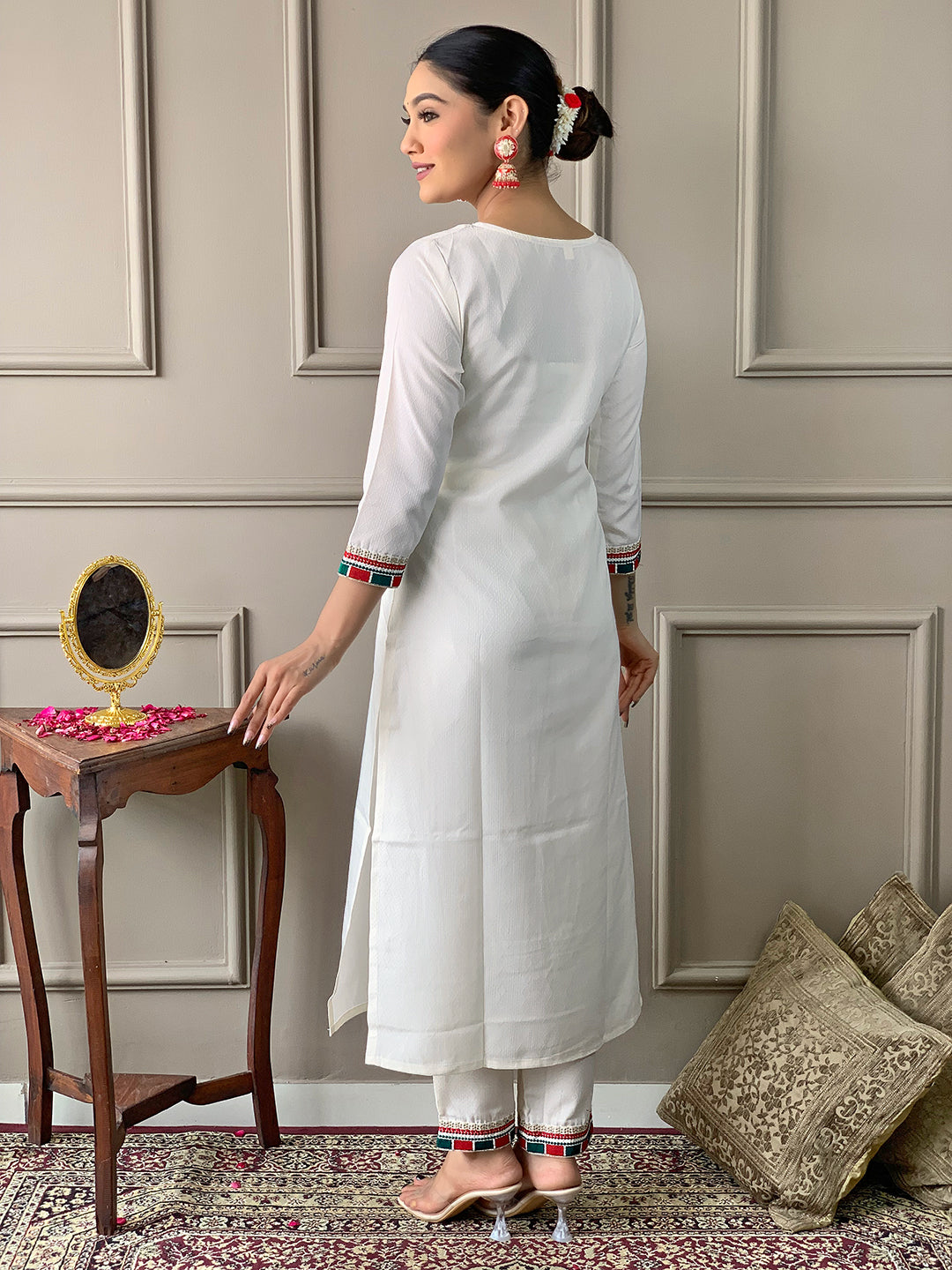 Rear view of a model in TRENDBUY D488 Off-White Kurta and Pant set, highlighting the simple back and striped cuffs and pant hem.
