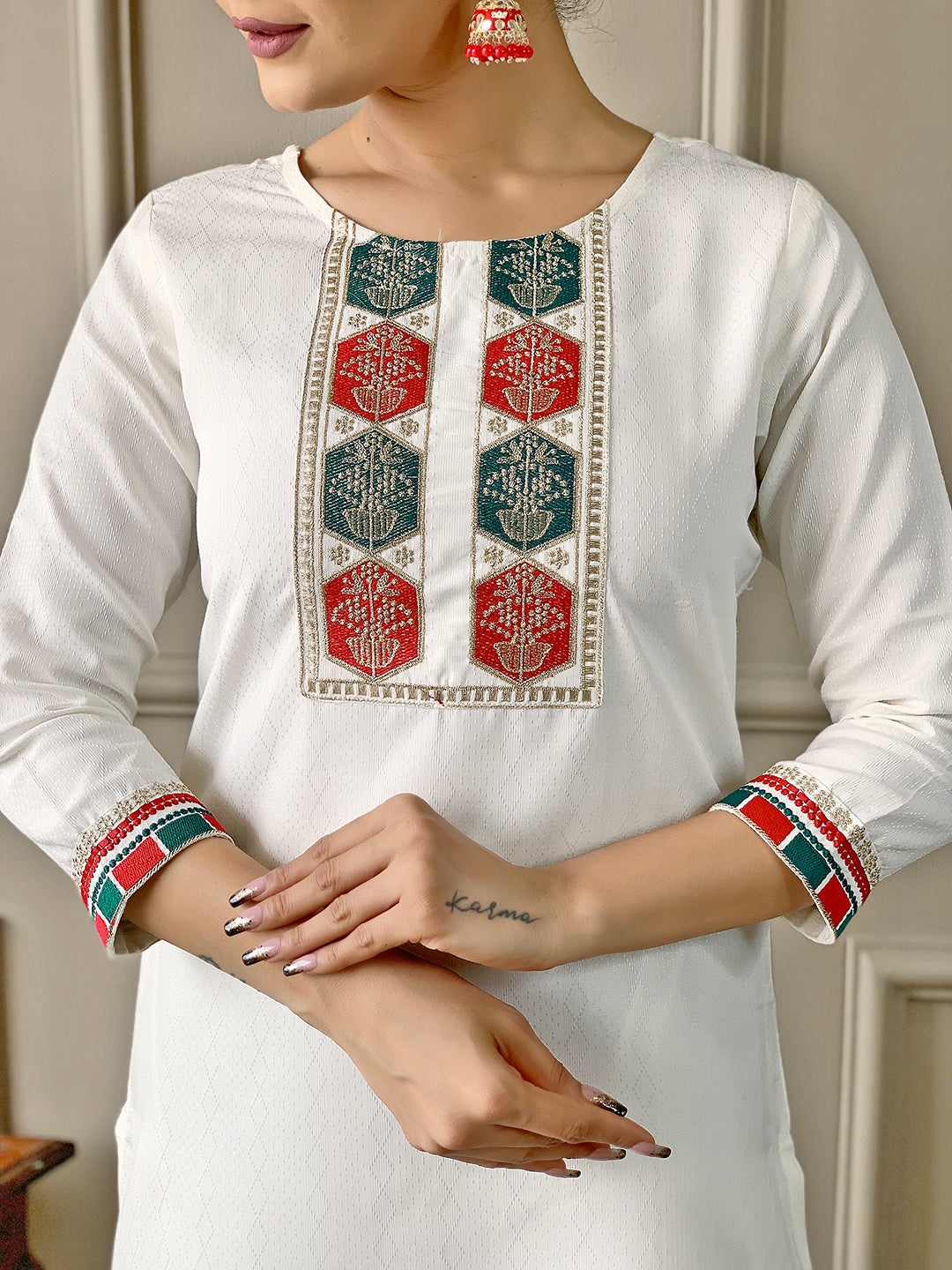 Close-up of the model's hands and the intricate embroidery on the yoke of the TRENDBUY D488 Off-White Viscose Kurta.