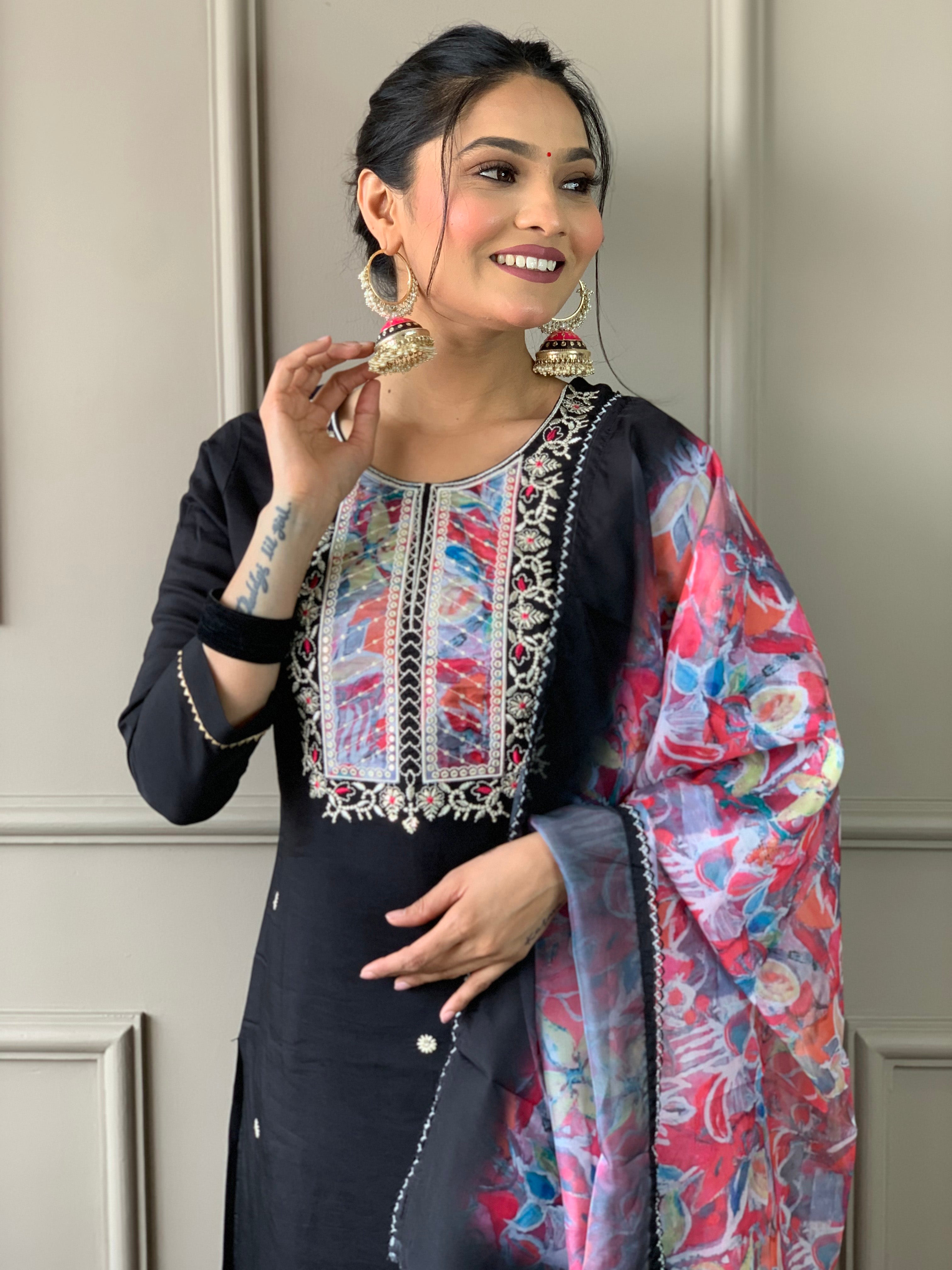 Close-up of woman's face and upper body, highlighting the intricate multi-color embroidery on the black TRENDBUY kurti and traditional jhumka earrings.