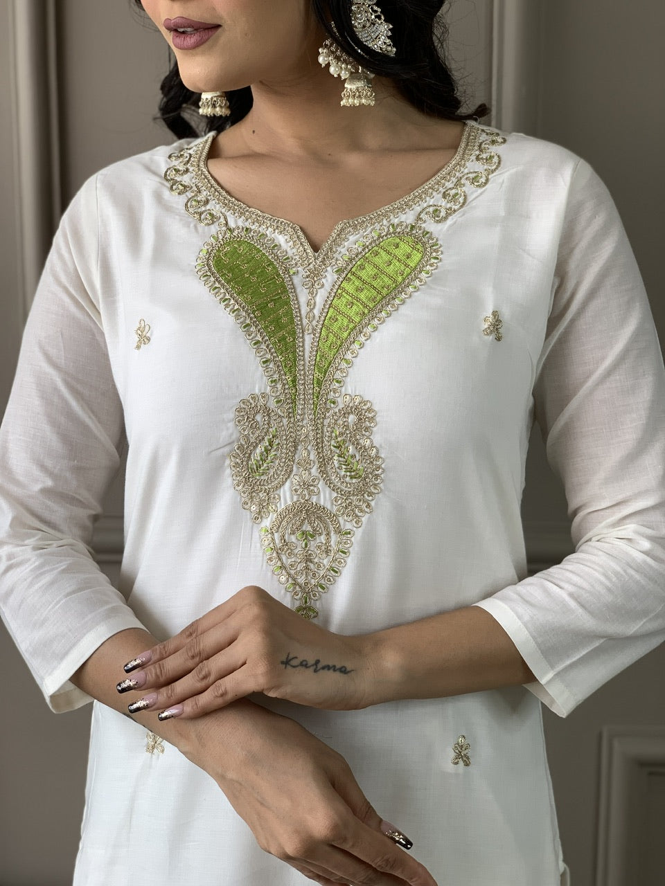 Close-up of the delicate green and gold embroidery on the neckline of the TRENDBUY Off-White Kurta.